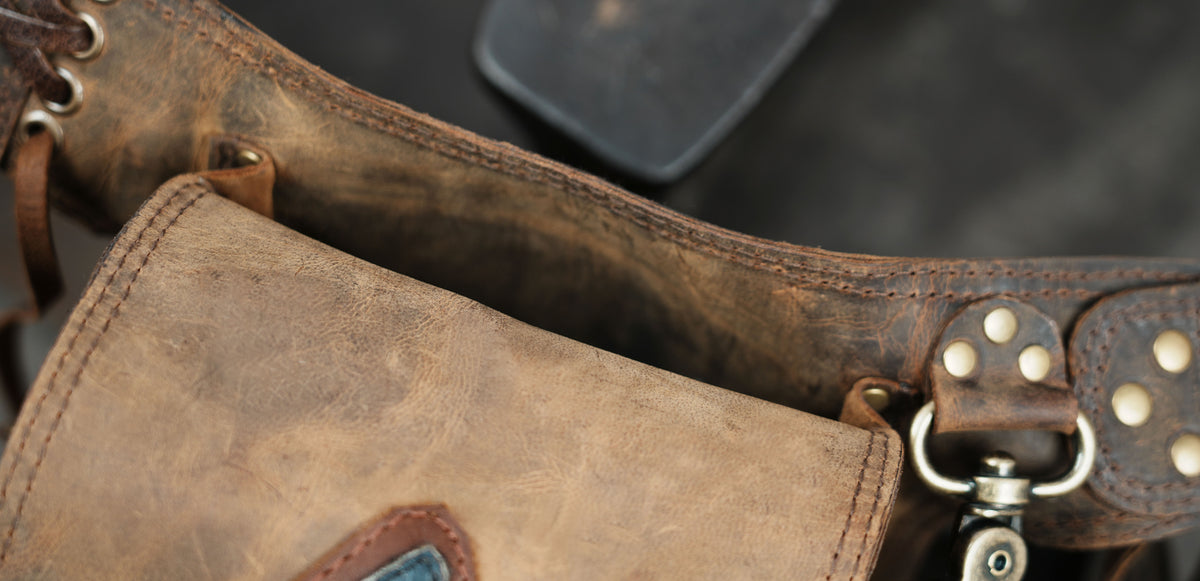 Rustic brown leather belt bag with decorative stone and fringeRustic brown leather belt bag with decorative stone and fringe