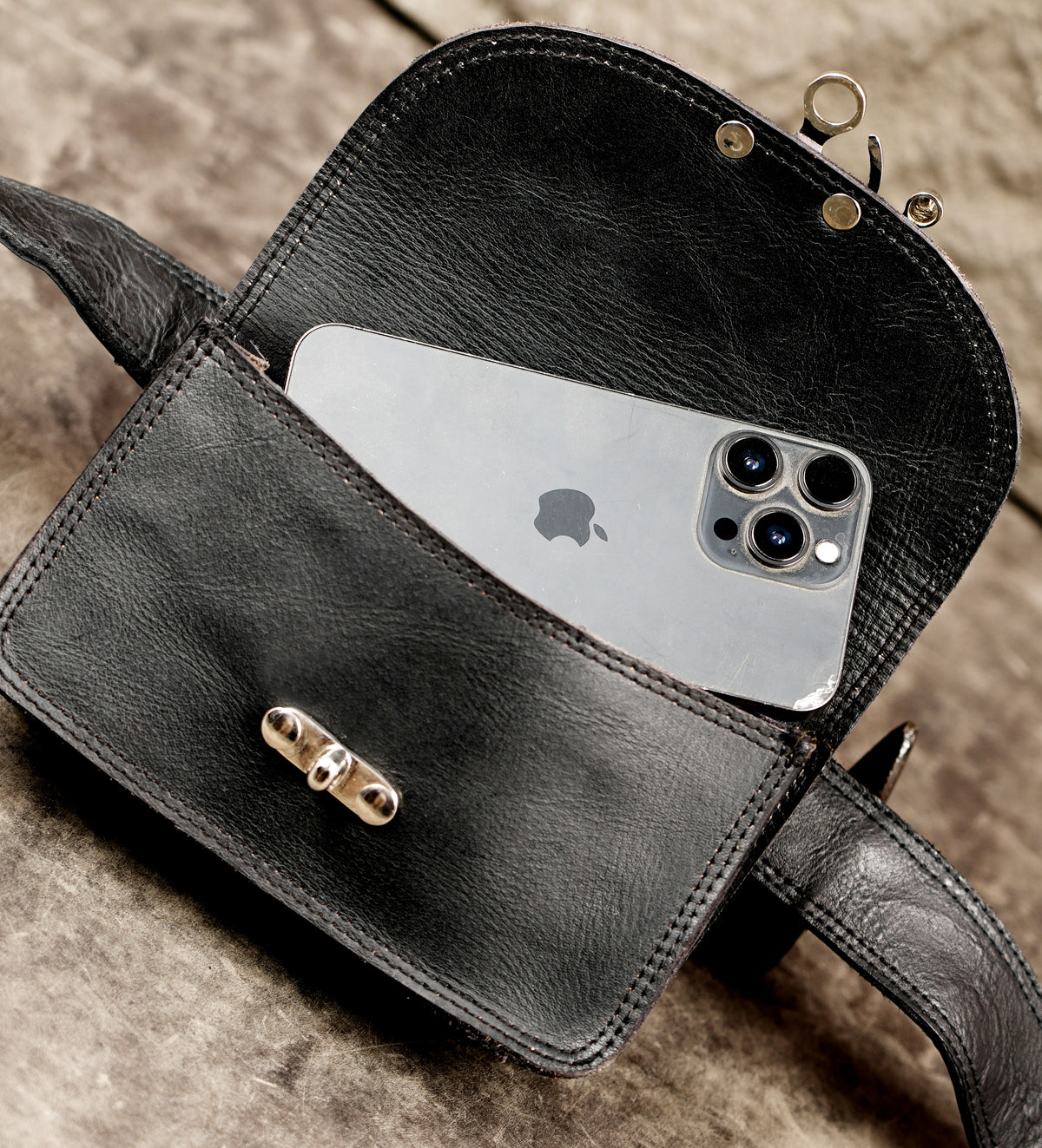 Clean leather hip bag with silver clasp, full flat lay view