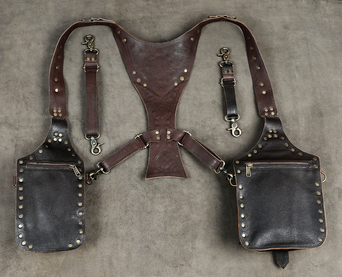 Leather dual pouch harness bag with adjustable buckles and detailed studded decorations.