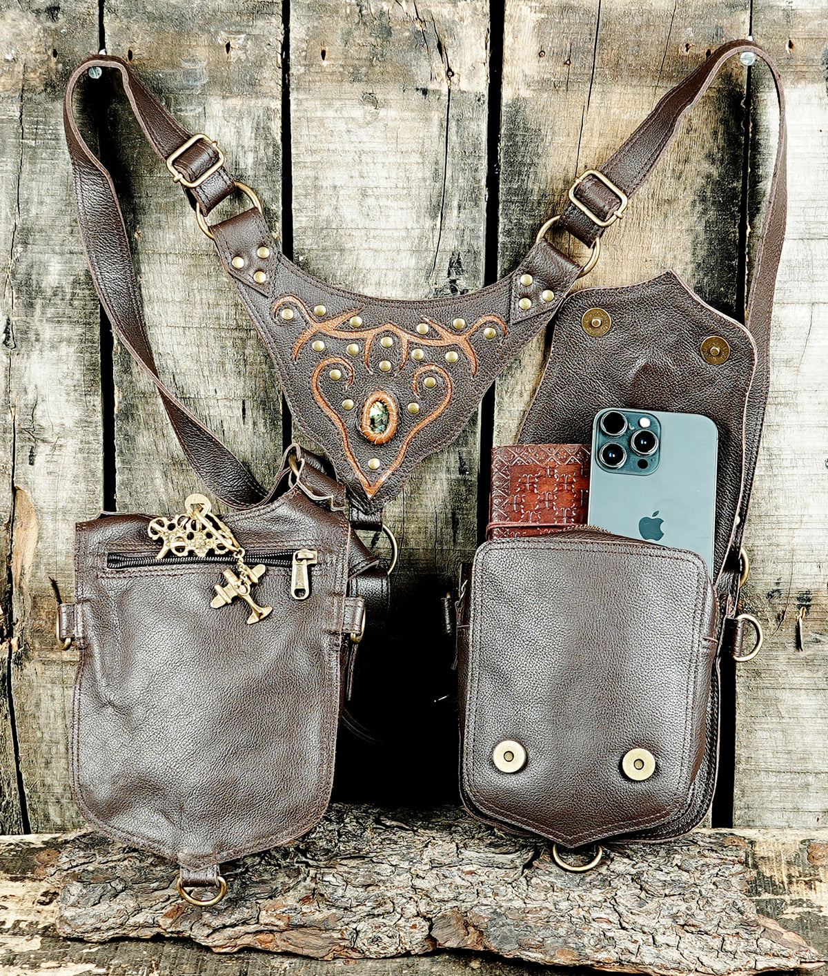 Black leather crossbody harness bag with two front pouches and brass fittings