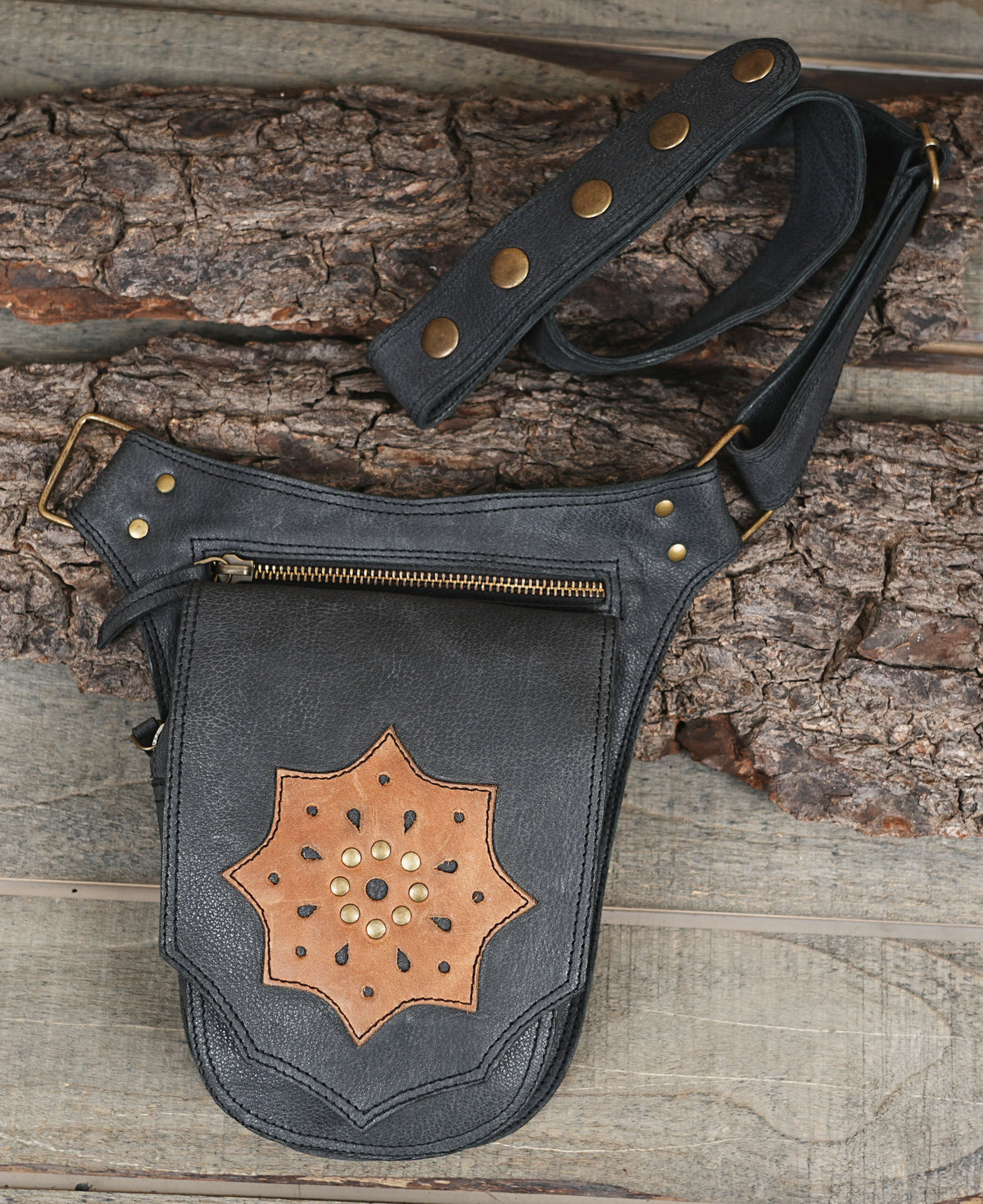 Dark boho black leather hip bag with brass hardware details