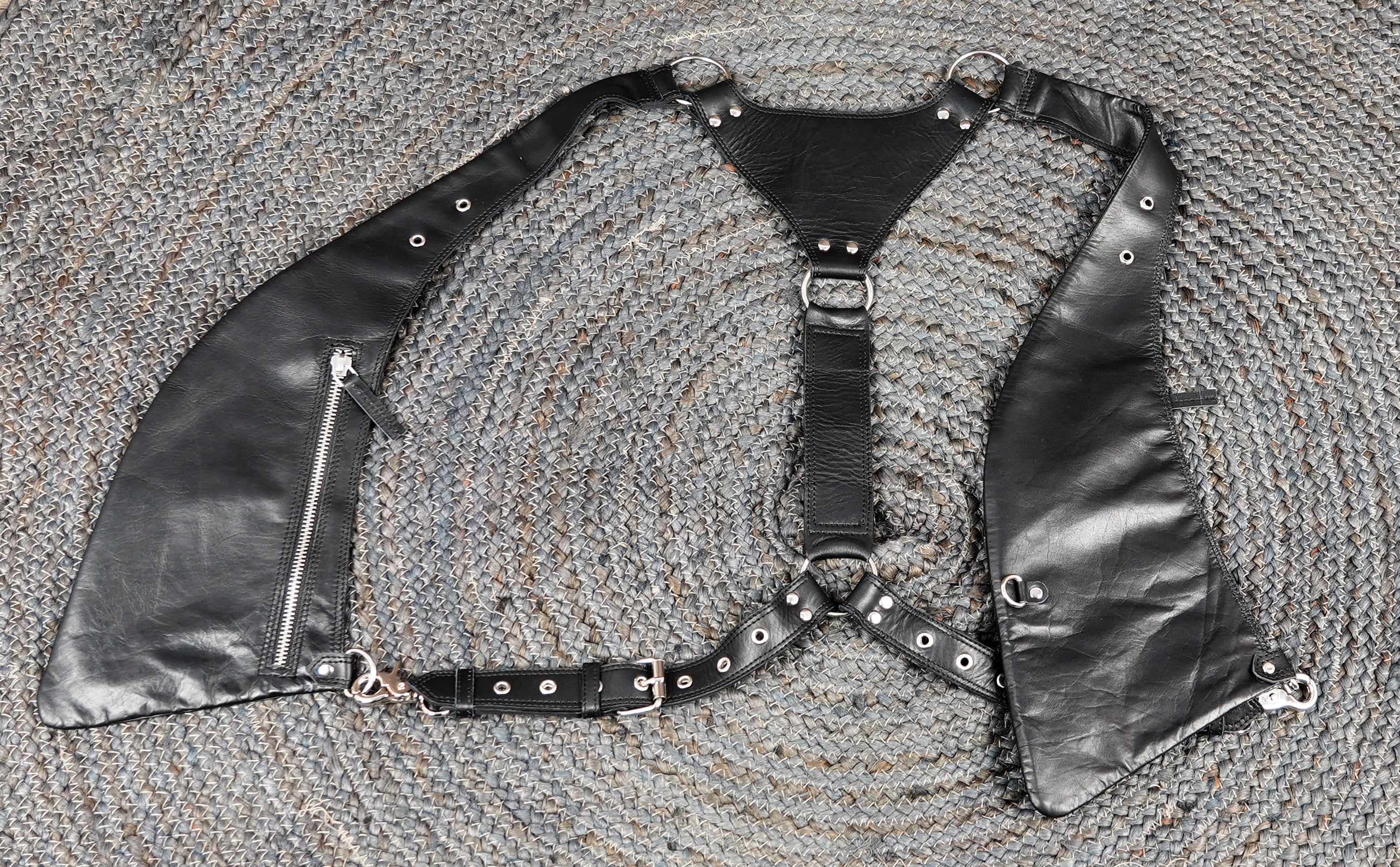 Black leather utility holster with adjustable fit and metal accents