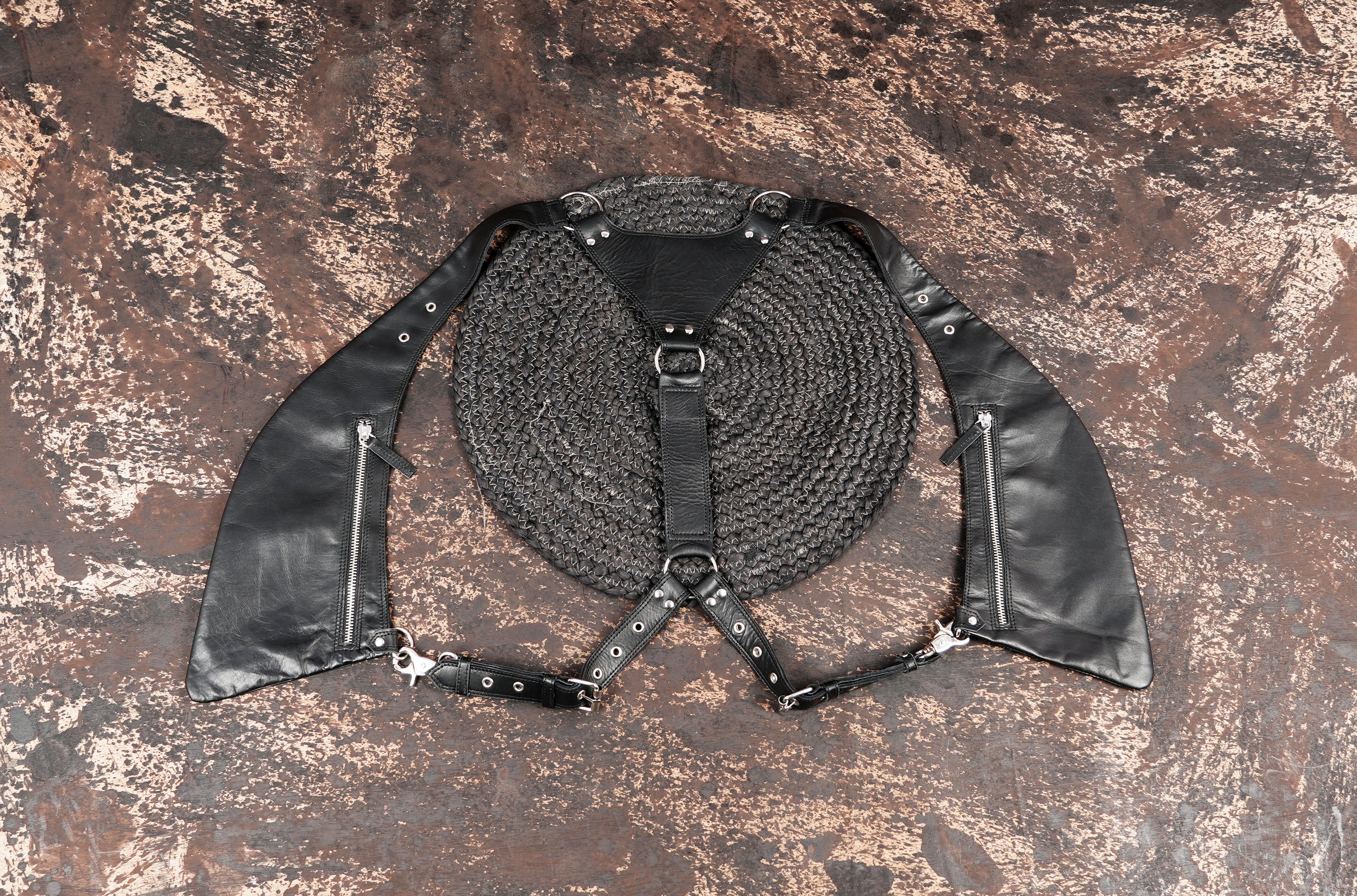 Black leather shoulder holster with zippered pockets and adjustable straps