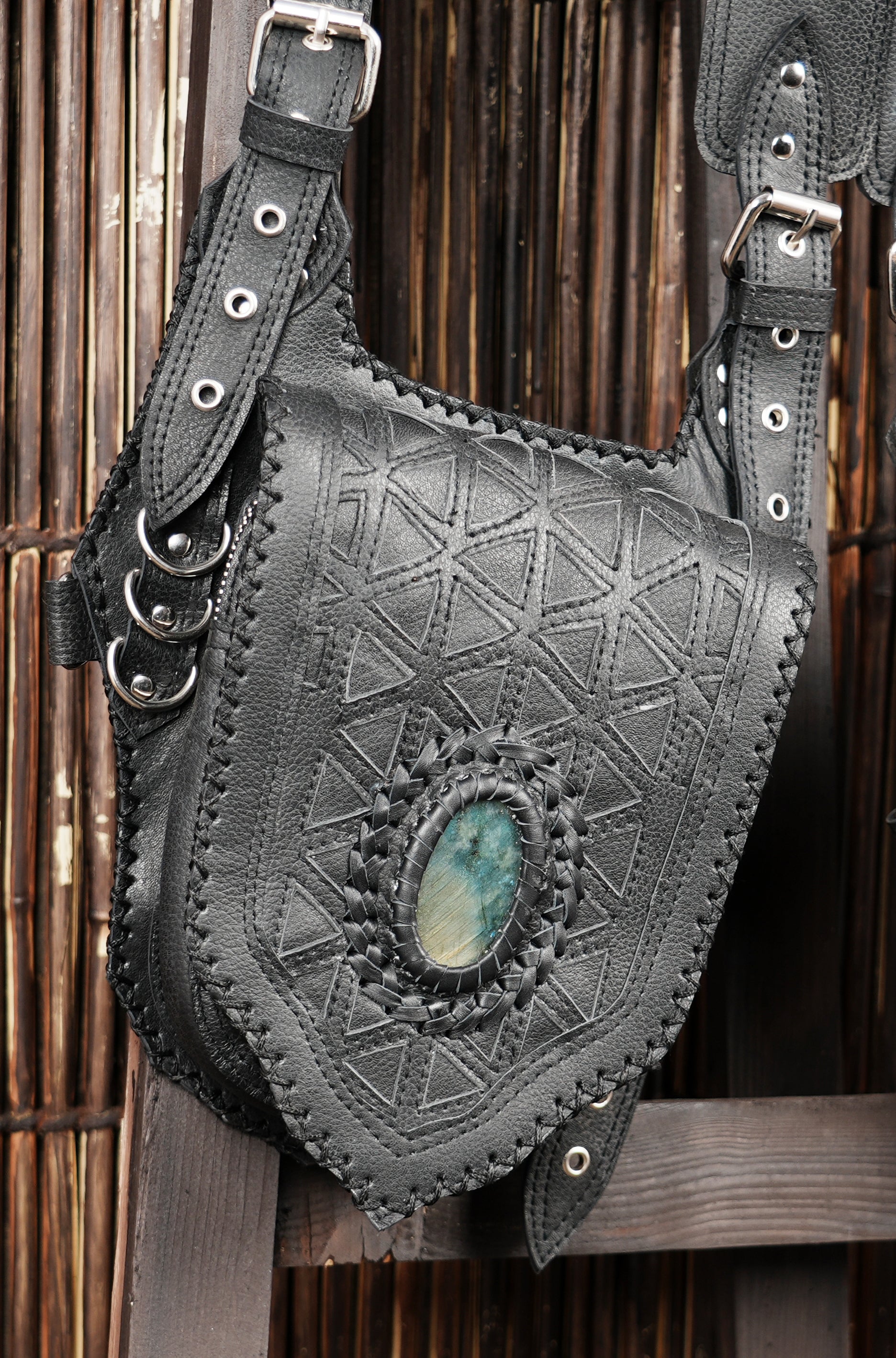 Adjustable black leather holster with geometric embossing and stone accent