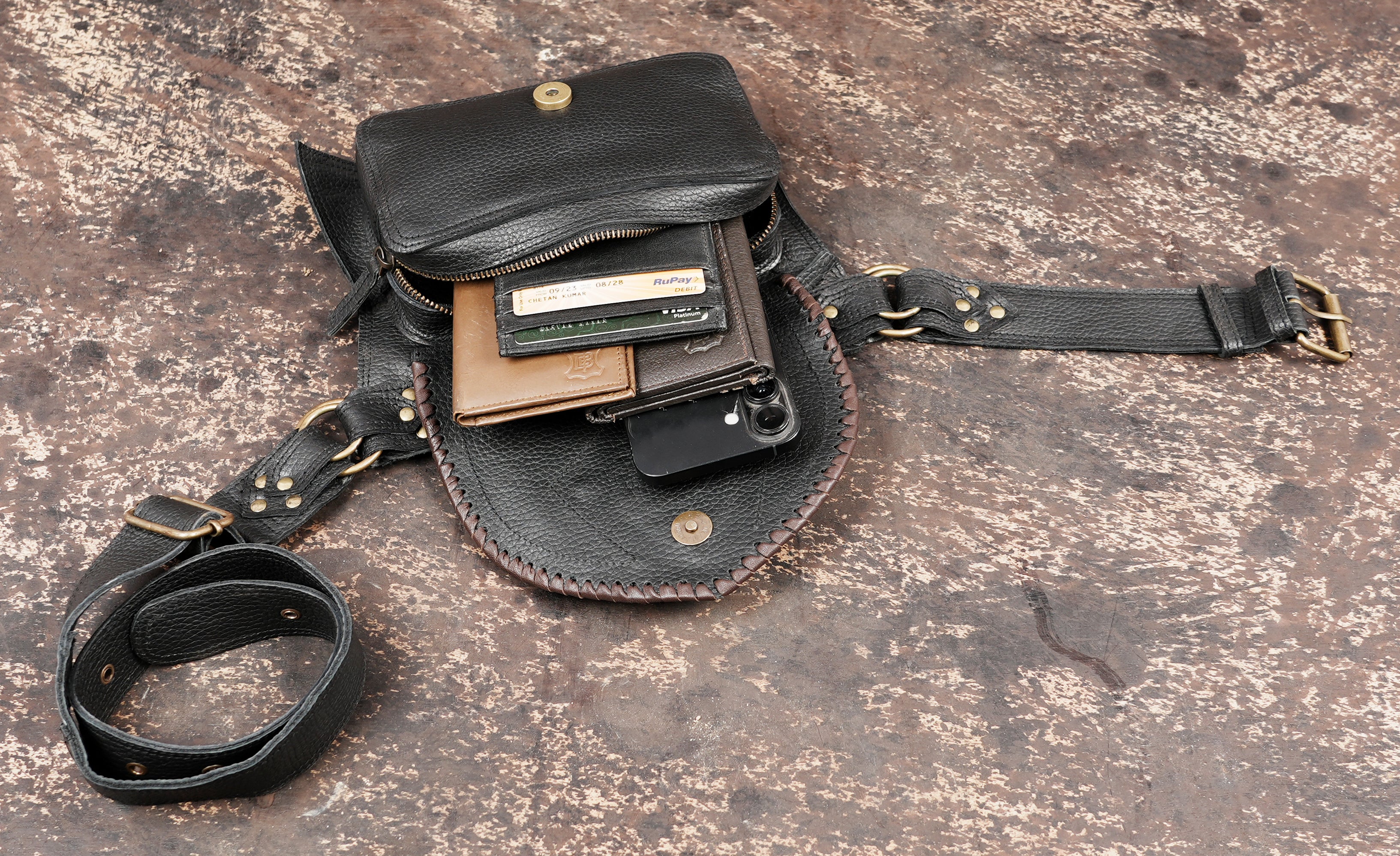 Leather hip pouch with decorative stitching and stone
