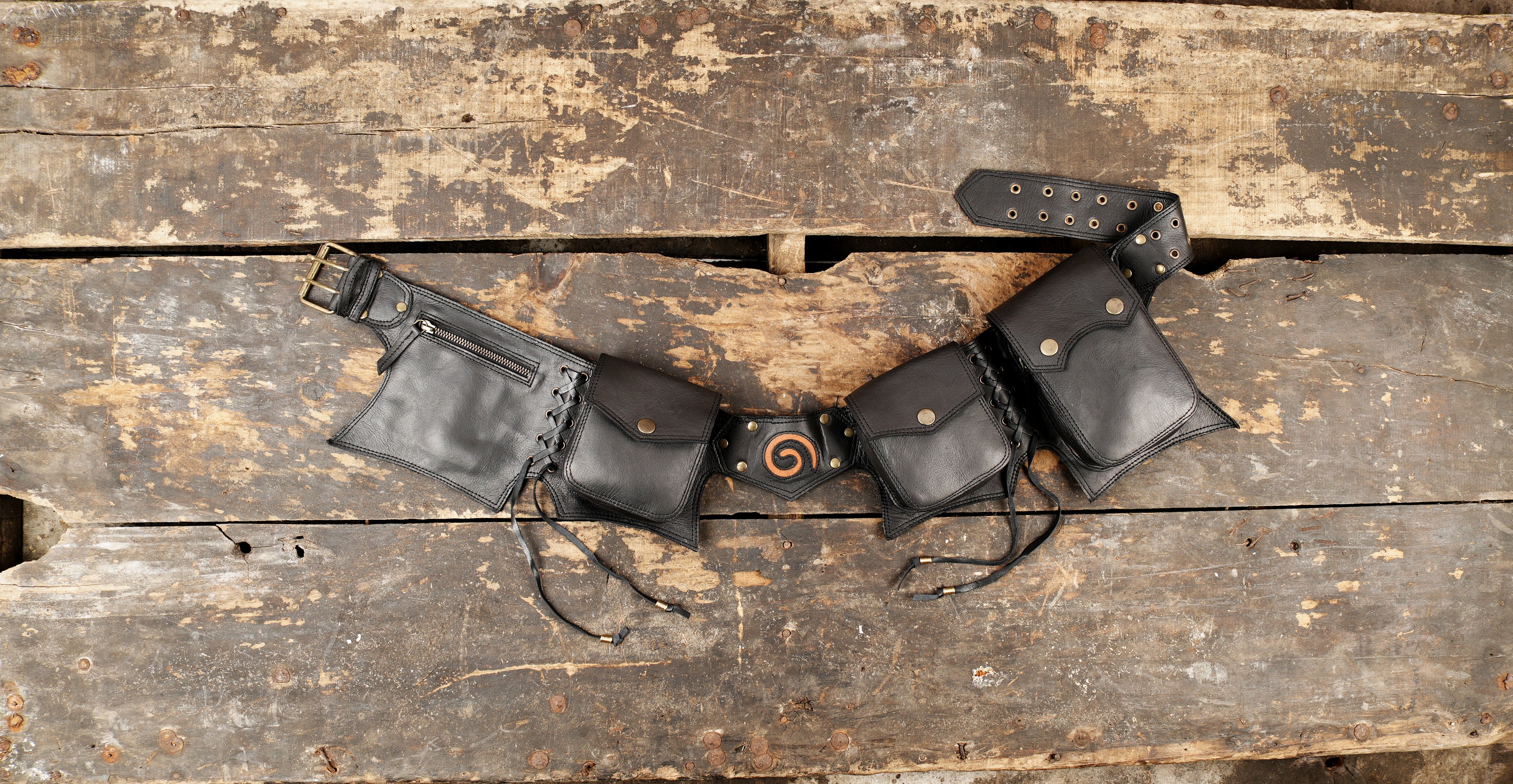 Medieval style black leather utility belt featuring snap pockets and an adjustable wide strap.