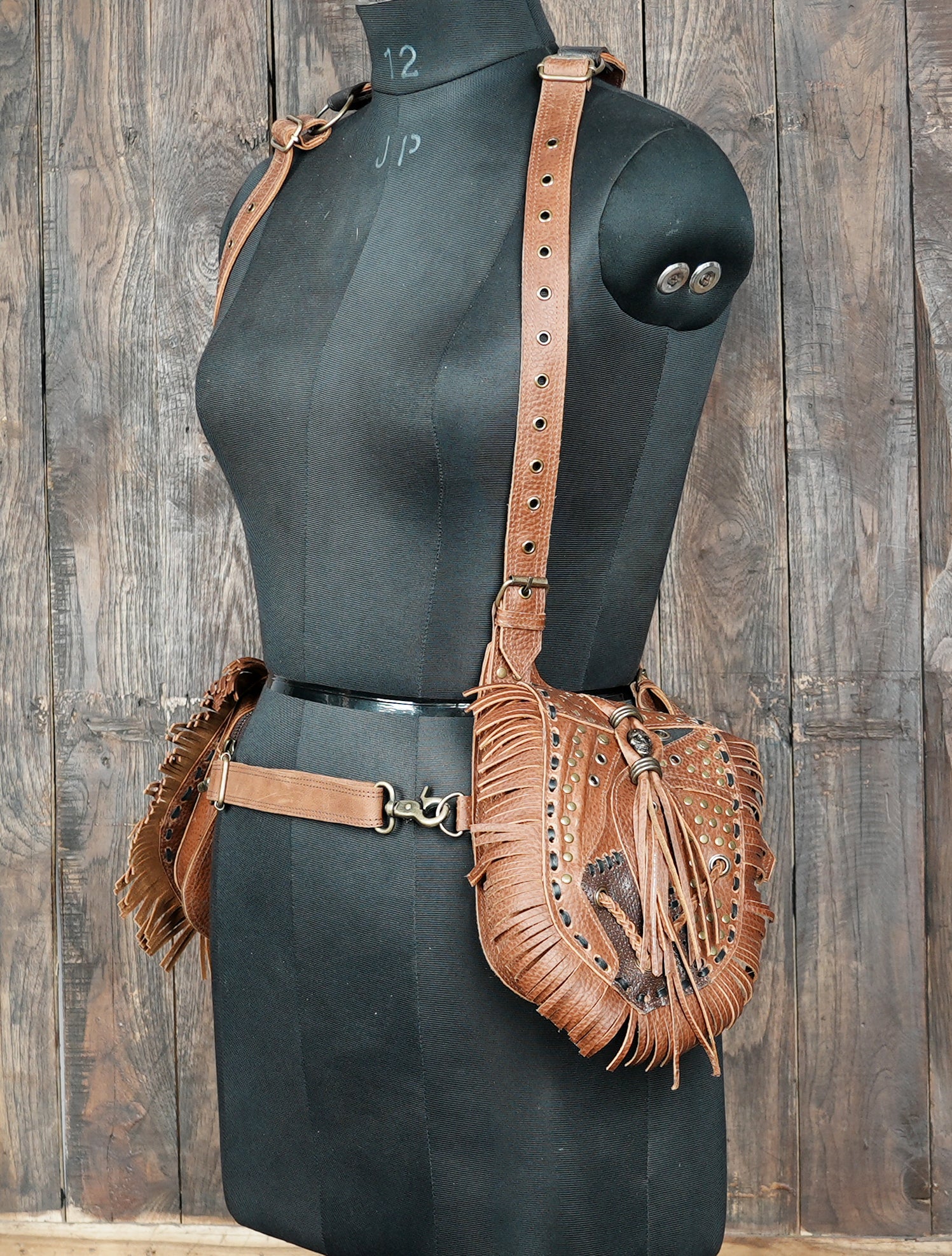 Handmade leather holster with studded design and fringe