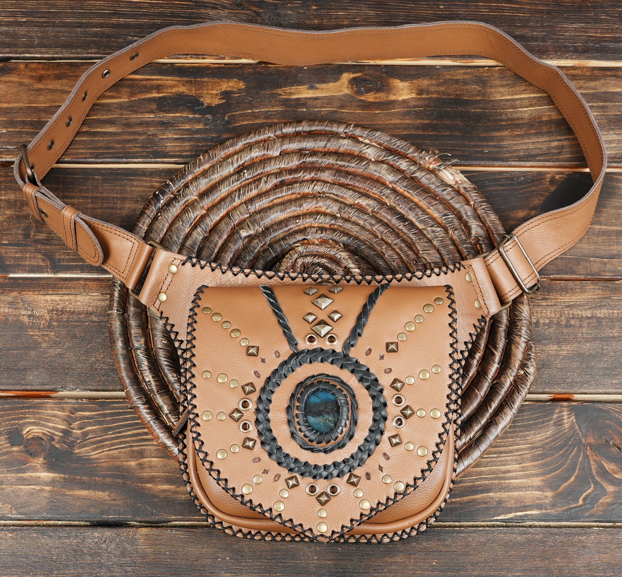 Brown leather waist bag with decorative studs and buckle strap