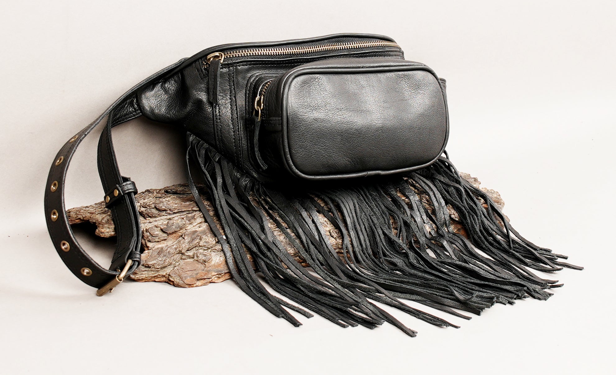 Black leather fanny pack with decorative fringe