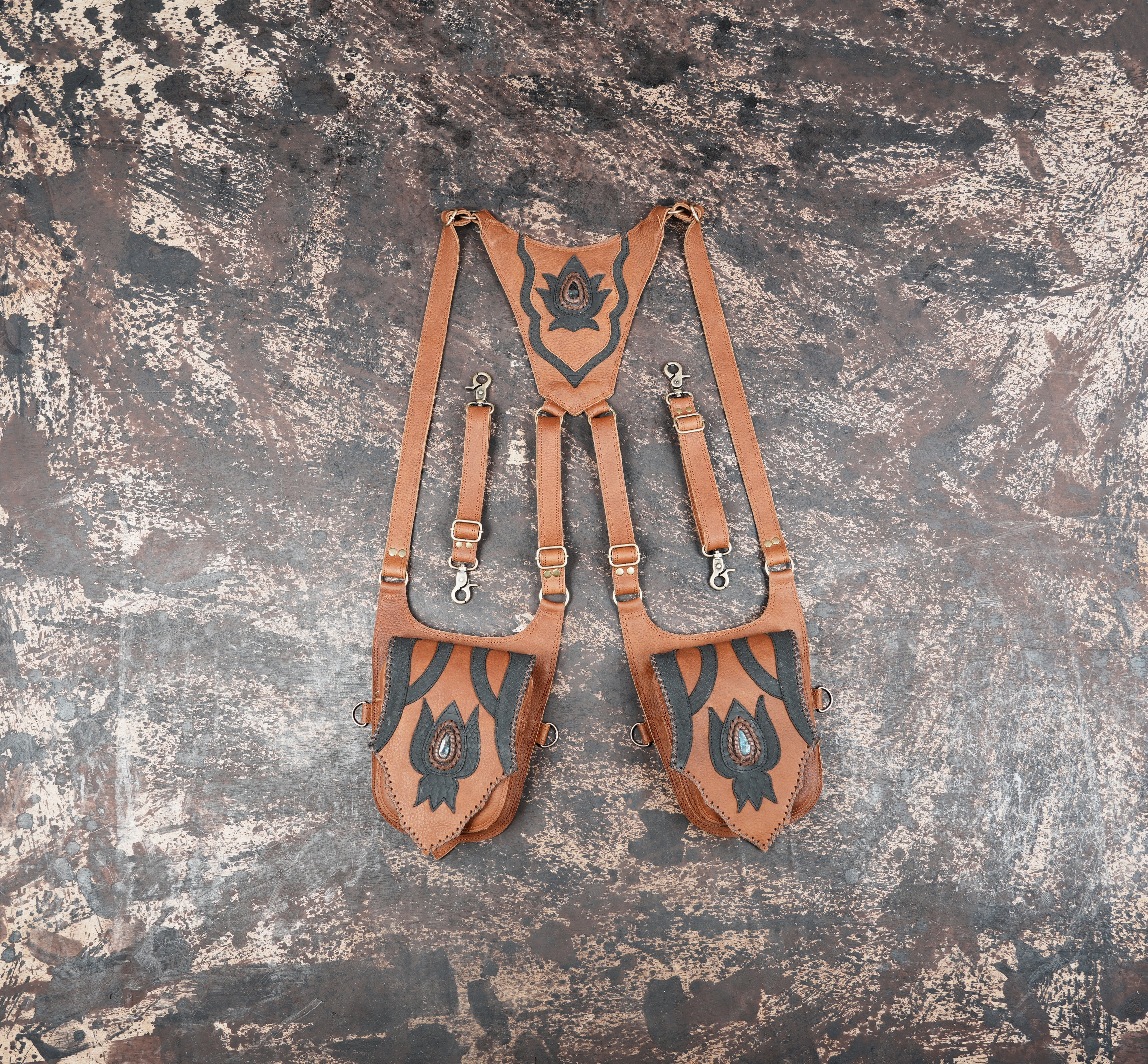 Handmade brown leather thigh holster with dual pouches and lotus design