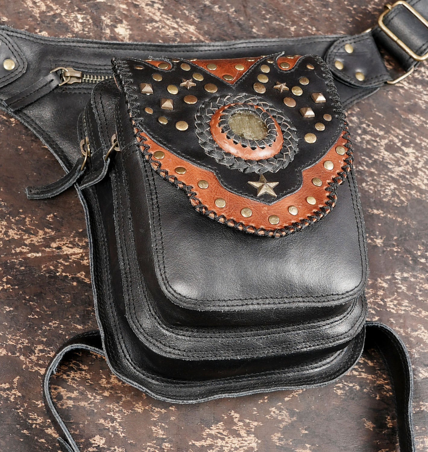 Black leather thigh belt bag with studded flap design