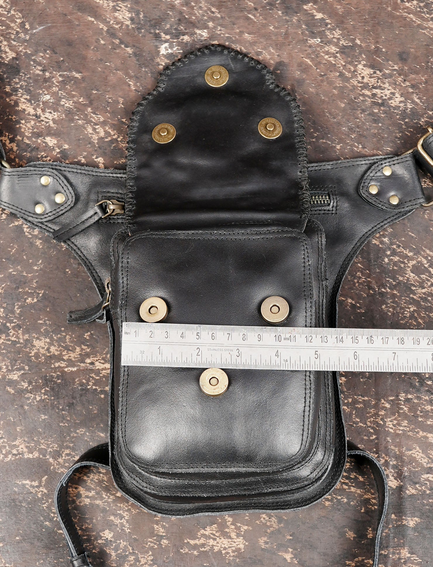 Black leather utility belt with decorative studs and metal accents