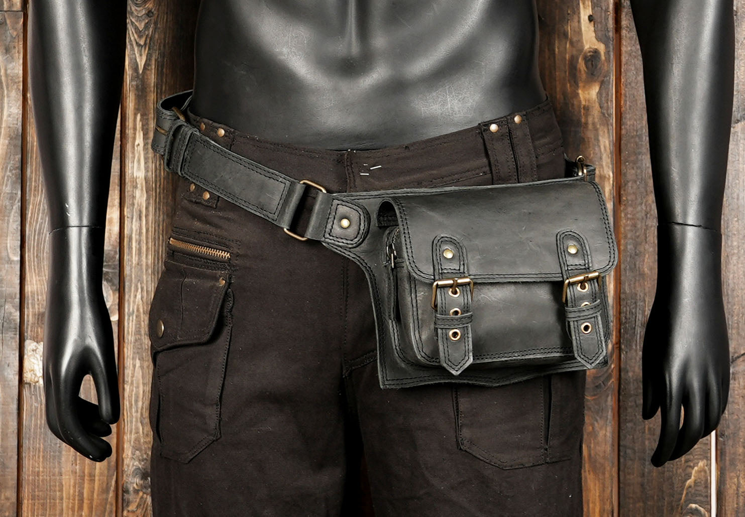"Premium black leather waist bag with stylish buckle detailing"