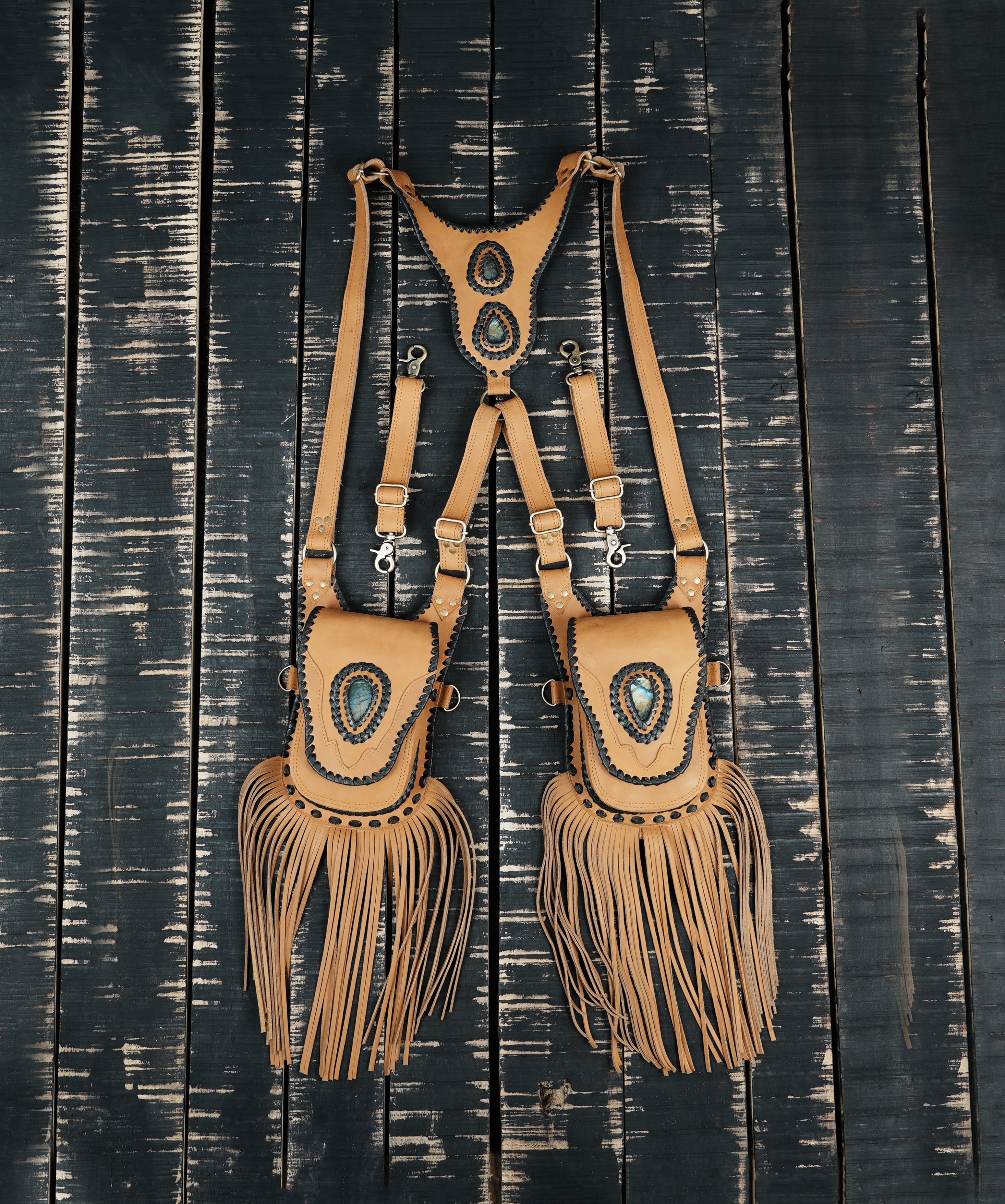 Handcrafted tan leather shoulder holster with gemstone detail and fringe design