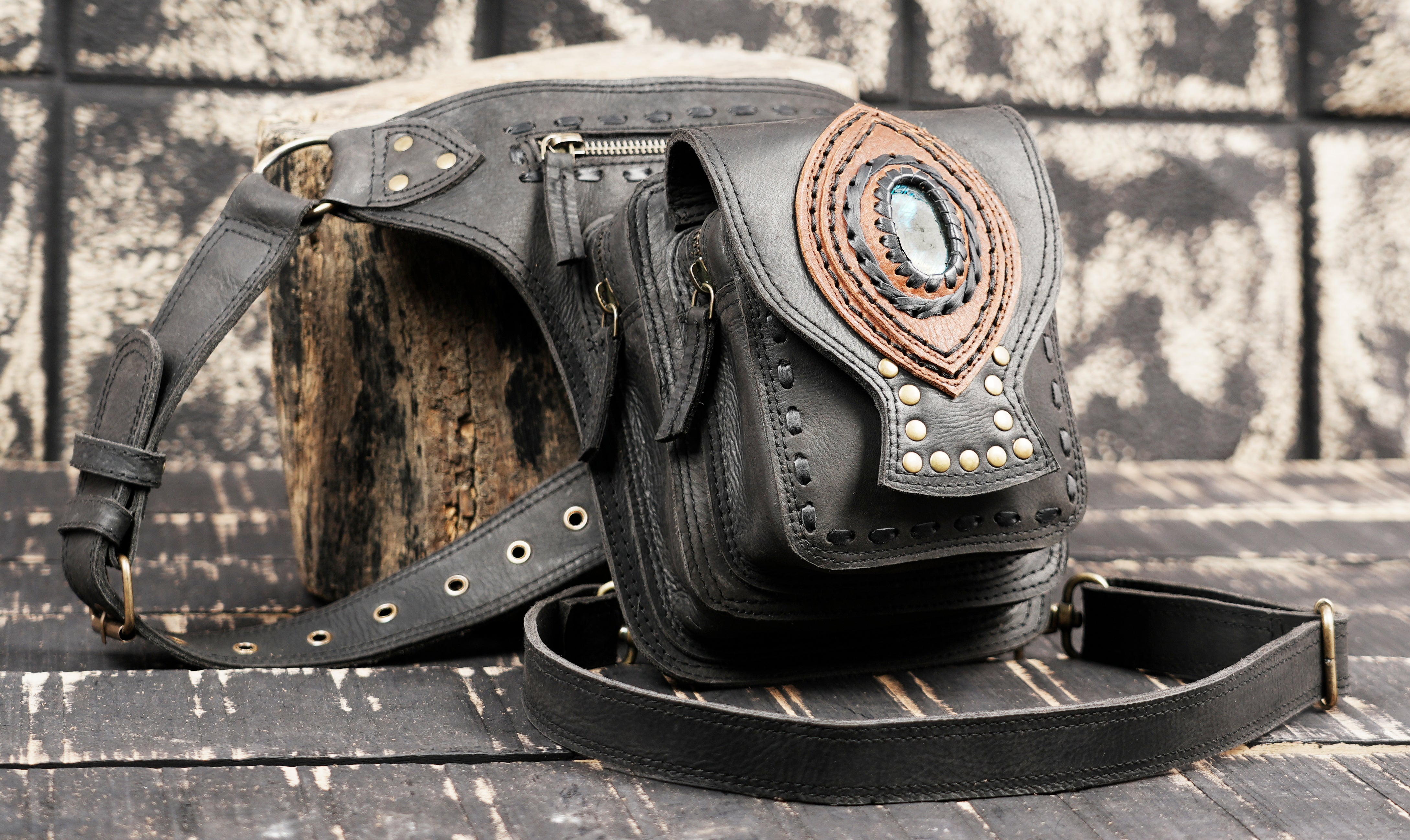 Adjustable black leather thigh belt with metal hardware