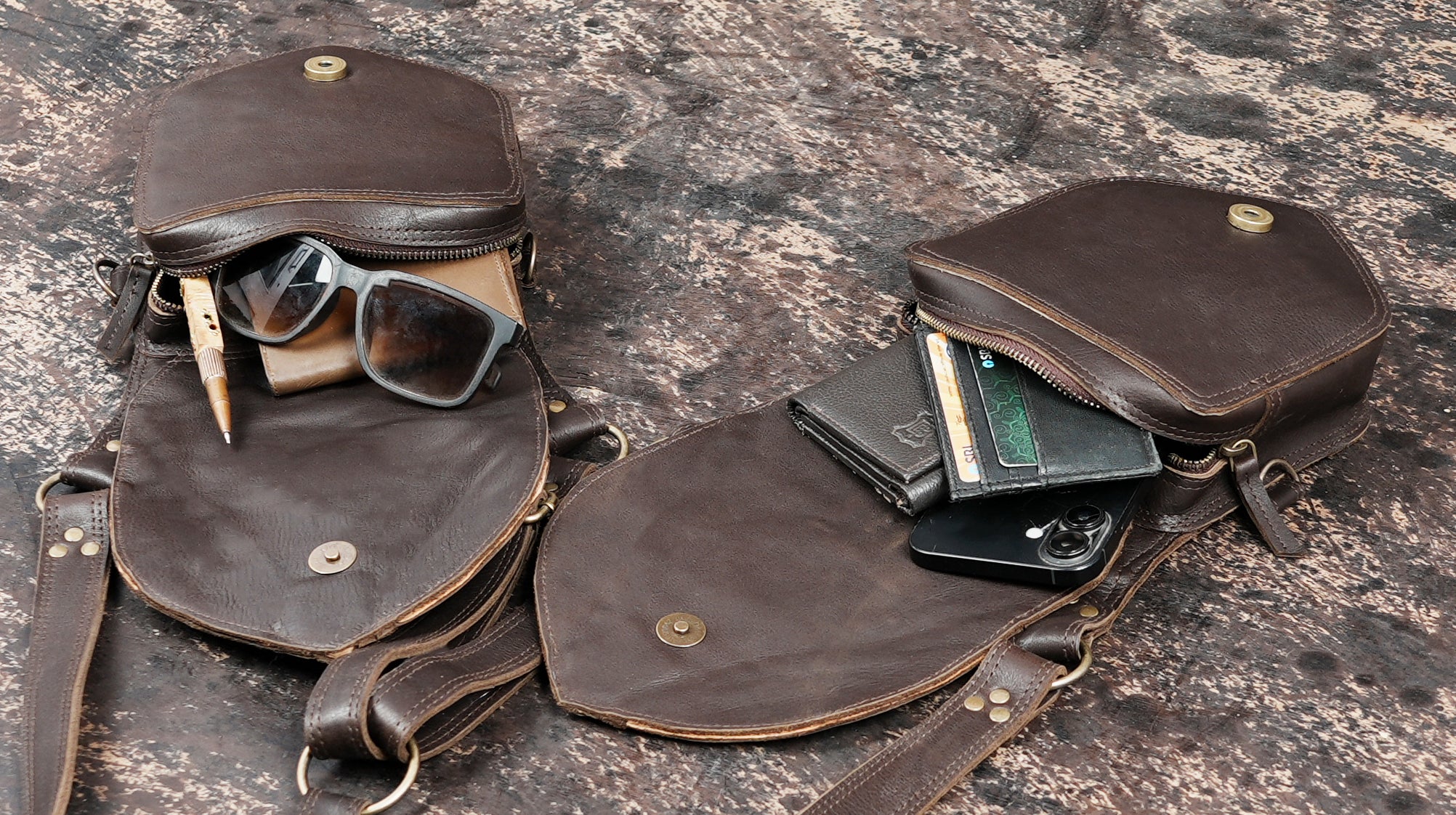 Artisan leather shoulder holster with metal hardware and rivets