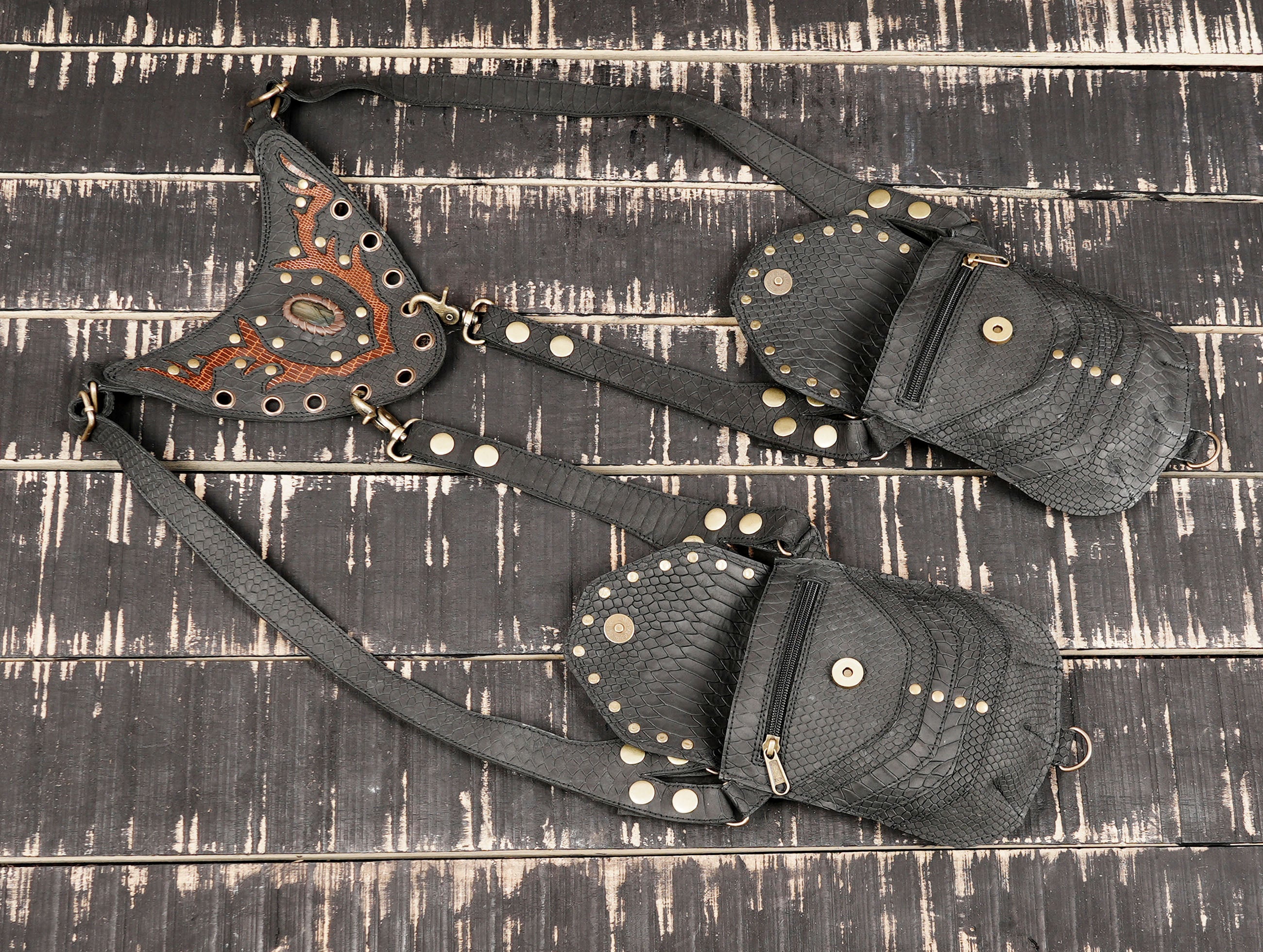 Handmade leather holster harness with snake pattern texture and stud finish