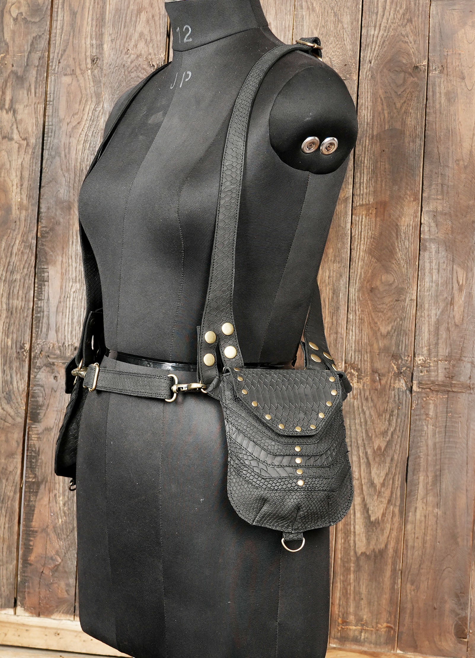 Black leather utility holster with antique brass fittings and adjustable fit