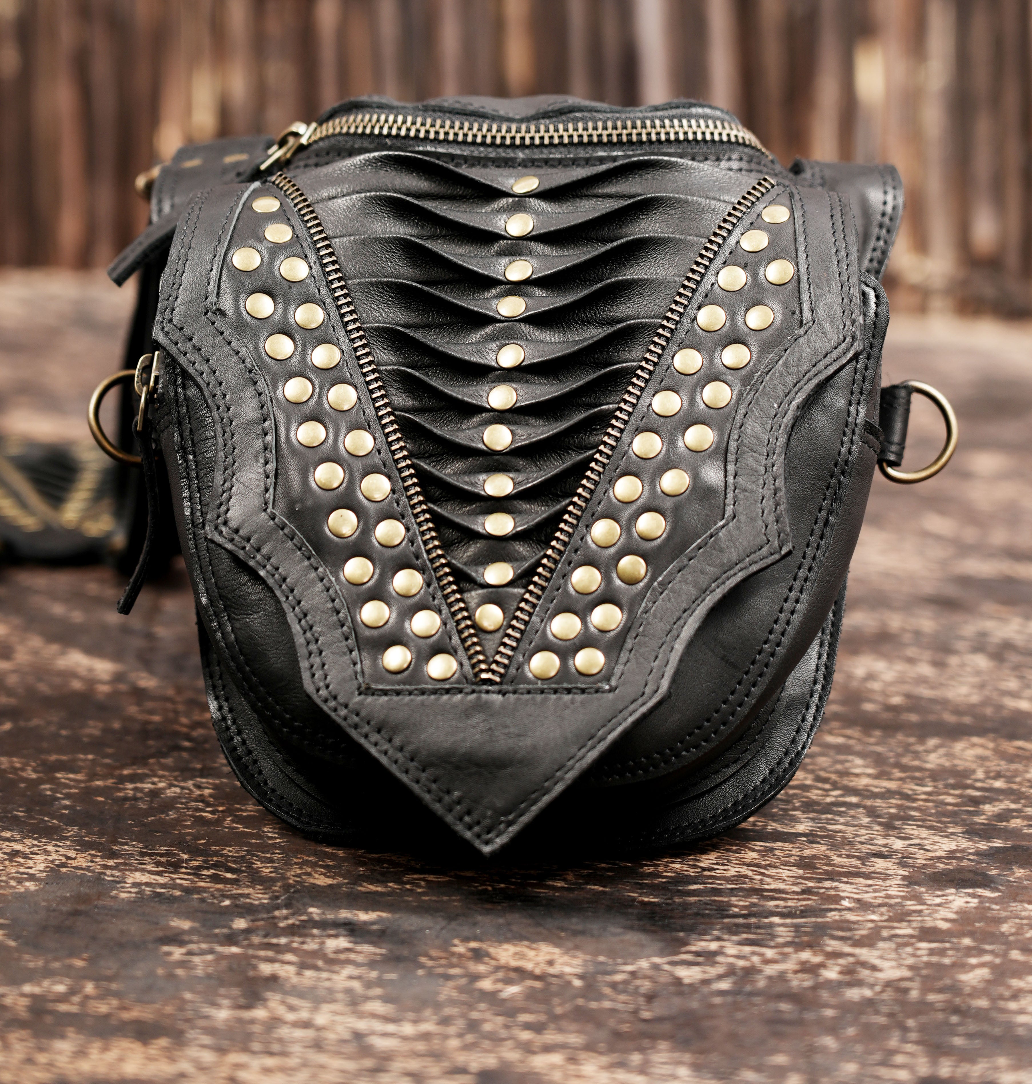 Steampunk style leather holster with twin utility pockets and metal hardware