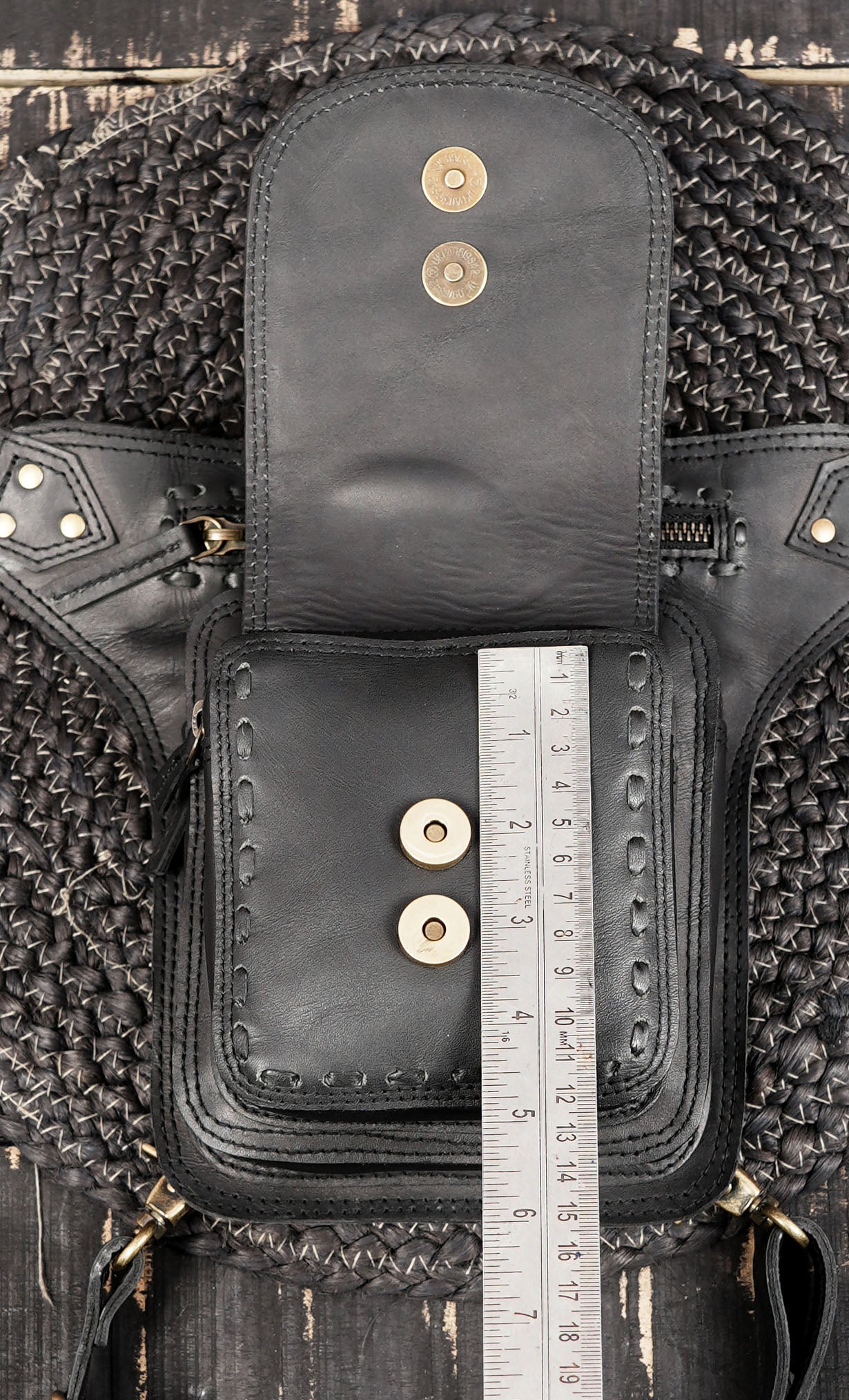 Sleek black leather thigh belt with adjustable fit and zipper pocket