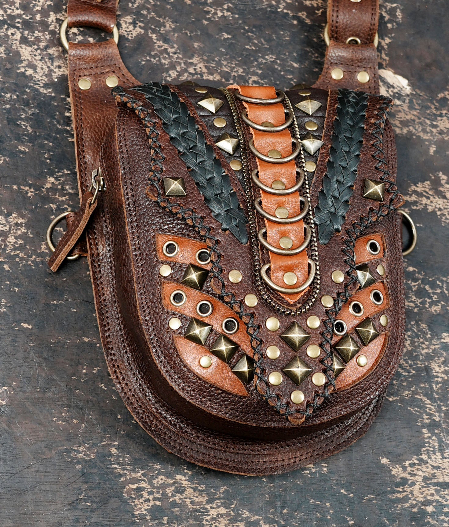 Brown leather holster harness with adjustable straps and metal rivets