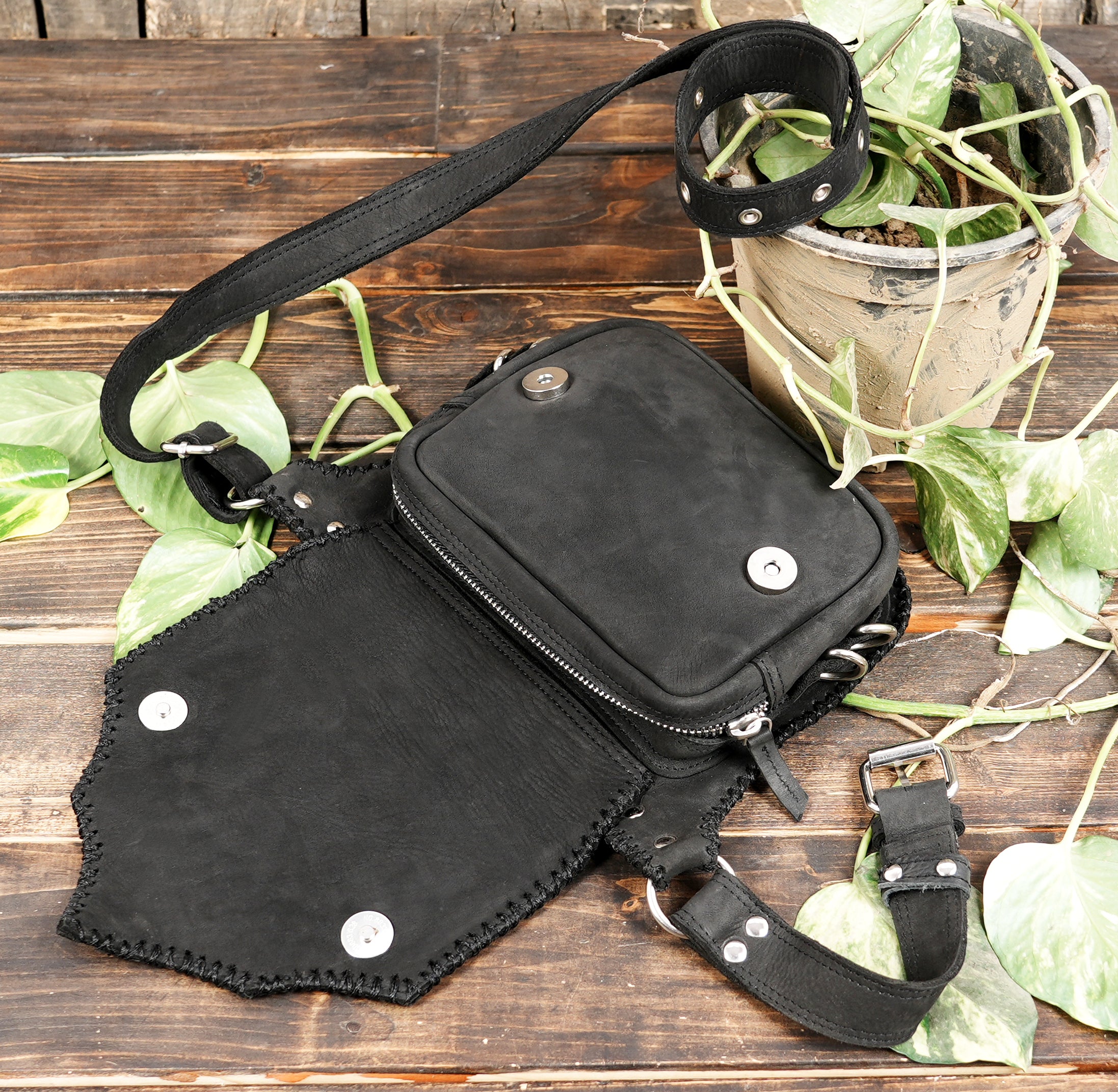 "Hand-stitched leather waist bag with detailed stud work"