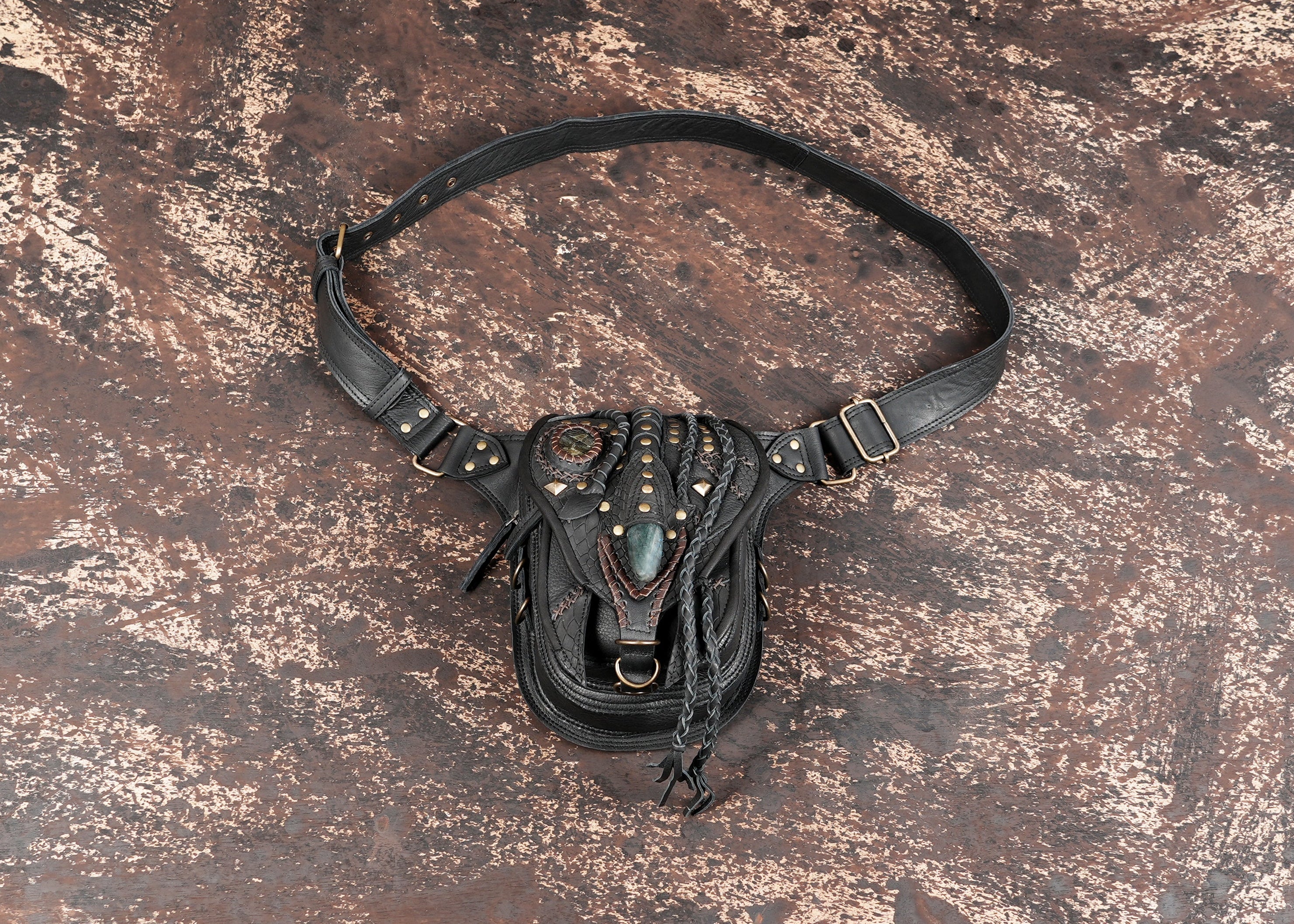 Handcrafted black leather waist belt bag with gemstone accents"