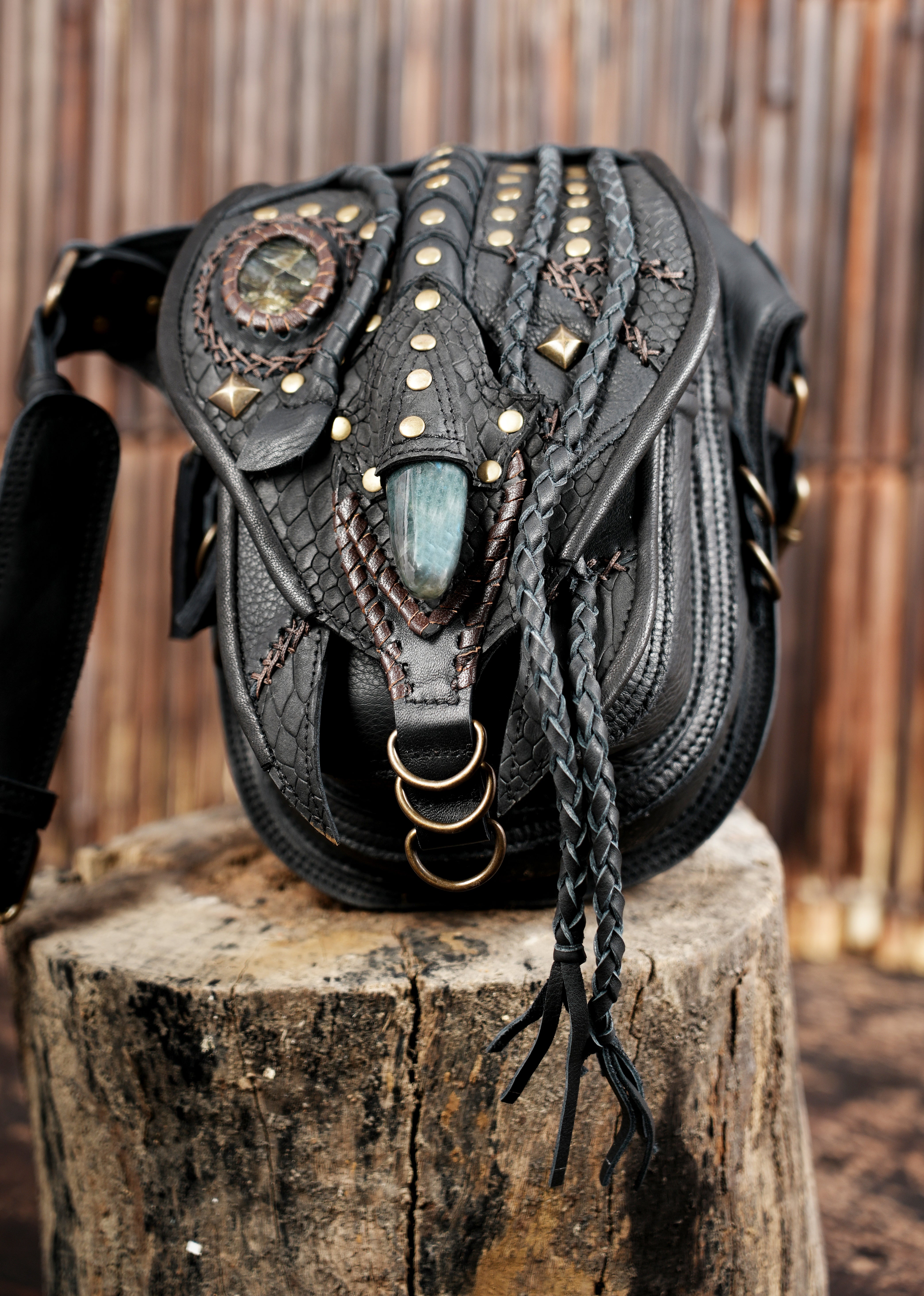 "Black leather festival belt bag with decorative stone centerpiece"