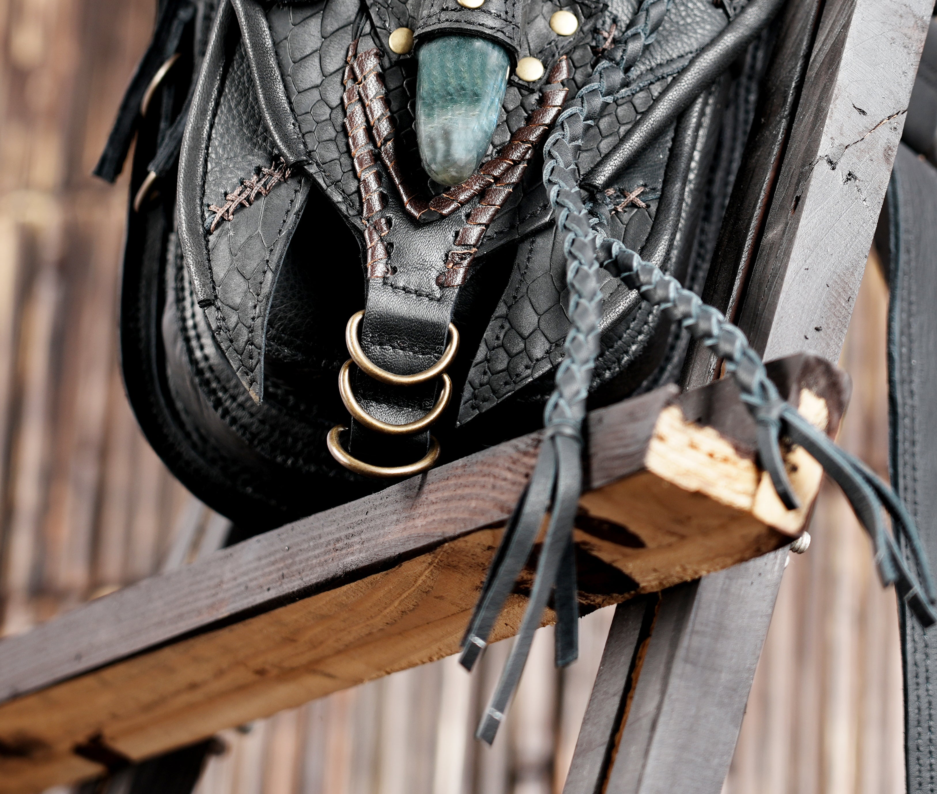 "Handmade leather belt bag featuring carved patterns and studs"