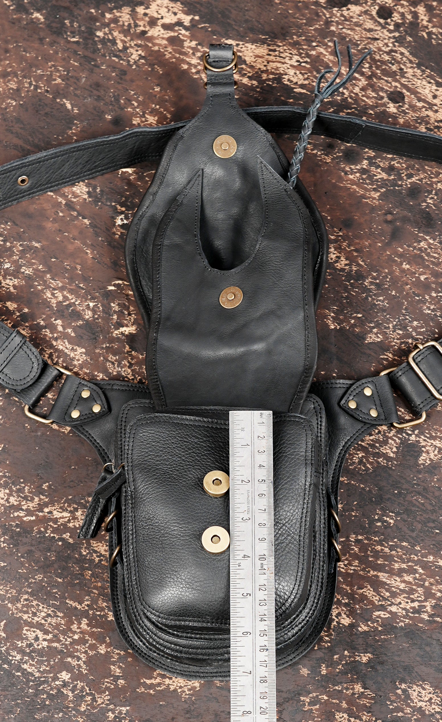 "Black leather travel waist bag with decorative stitching"