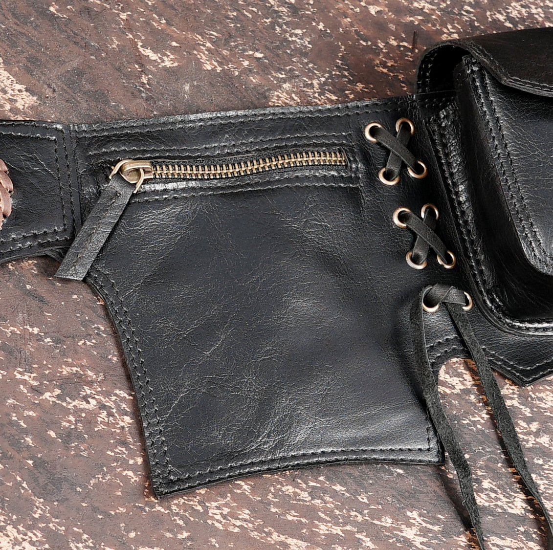 Adjustable black leather belt with pockets and gemstone accent