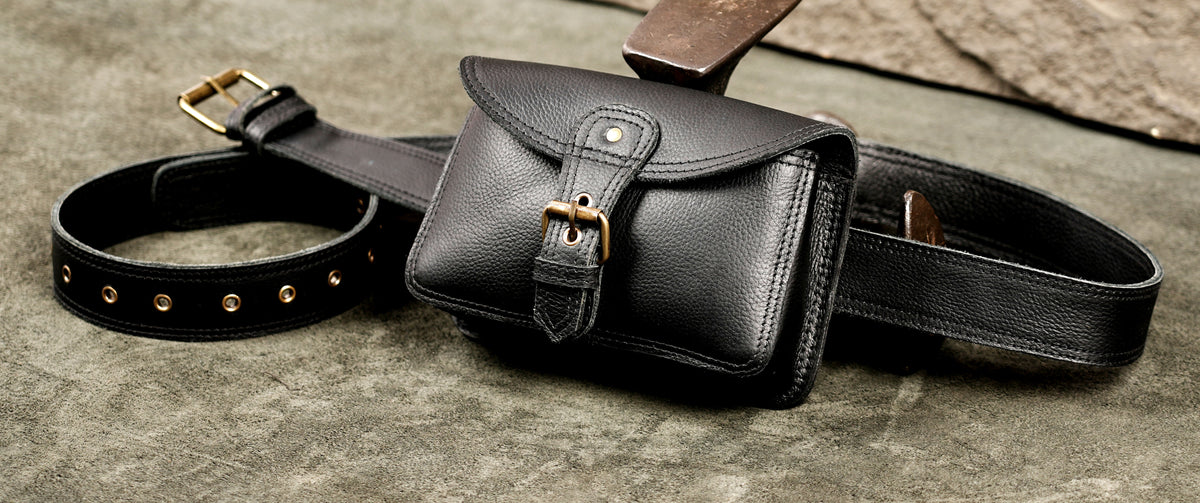 Classic black leather waist pack with antique brass buckle strap