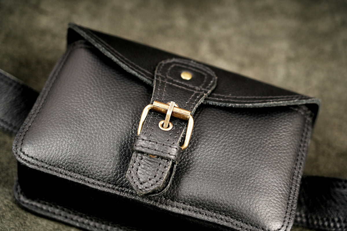 Black pebble grain leather fanny pack with adjustable brass buckle belt