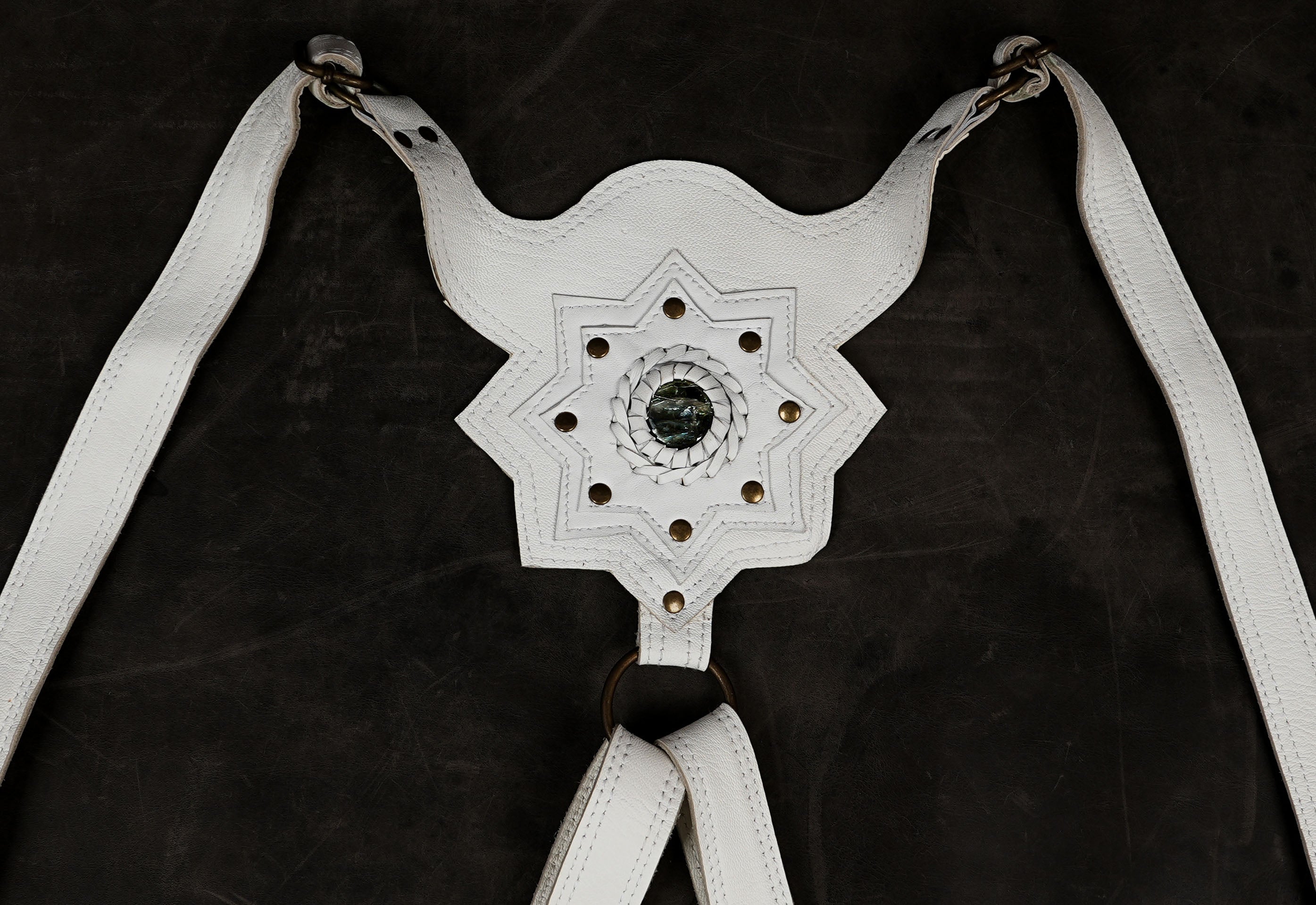 Fantasy character harness in ivory, dark background shot