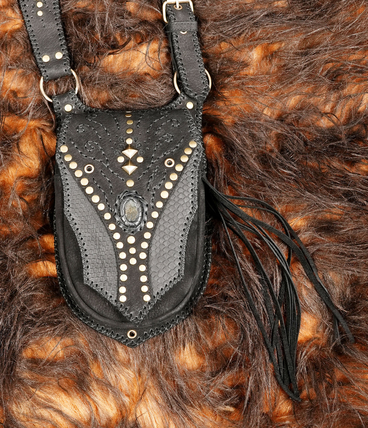 Handmade black leather bags with adjustable harness straps for rave wear and festival styling.
