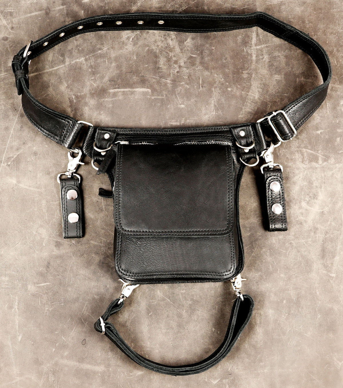 Front view of handmade black leather drop-leg utility bag