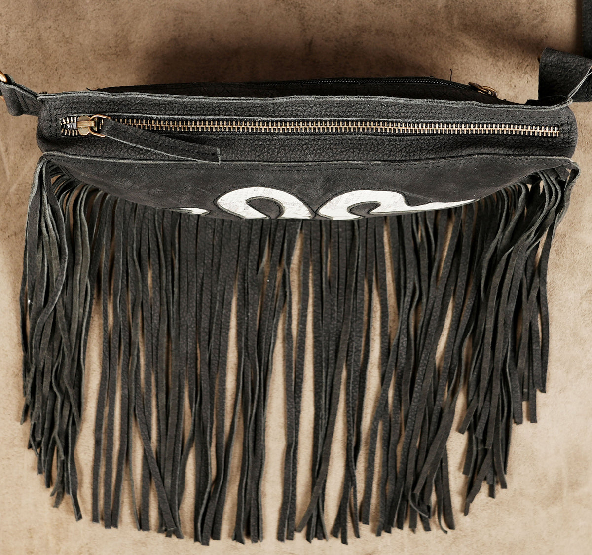 Gothic black waist bag with white snake design and dramatic fringe for alternative fashion.