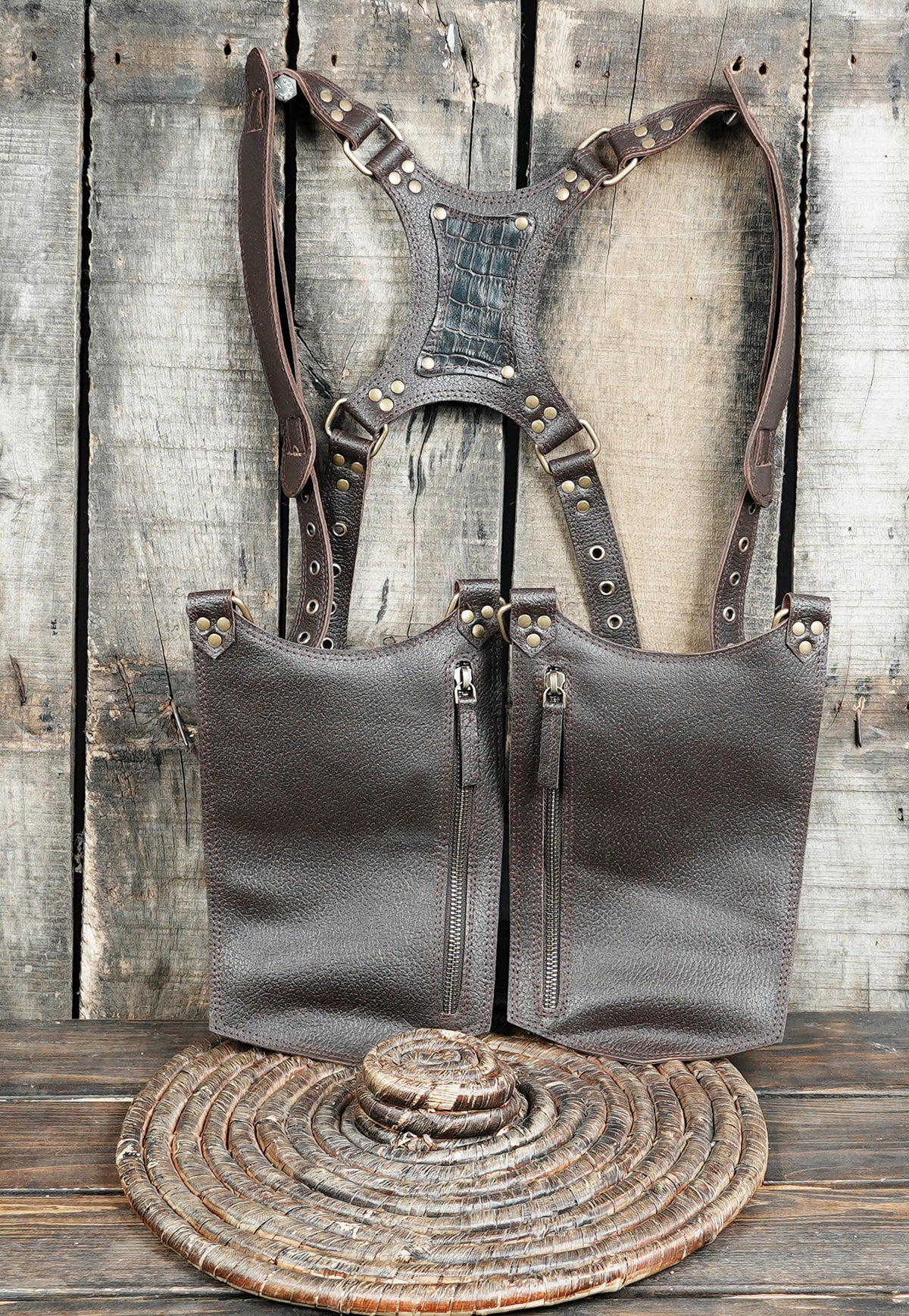 Dark brown leather double pouch harness with metal eyelets and decorative brass studs.