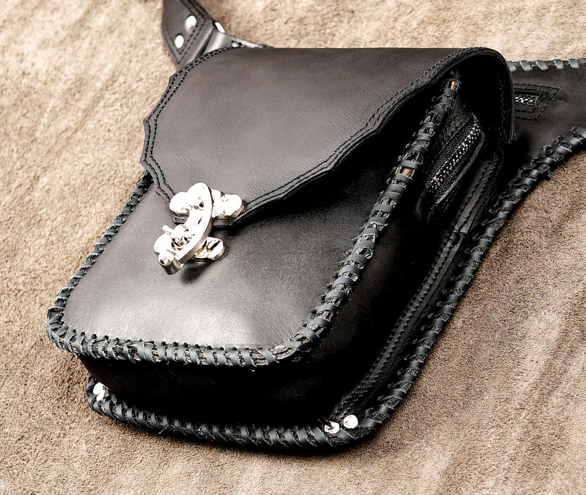 Glossy black leather pouch with braided edge trim