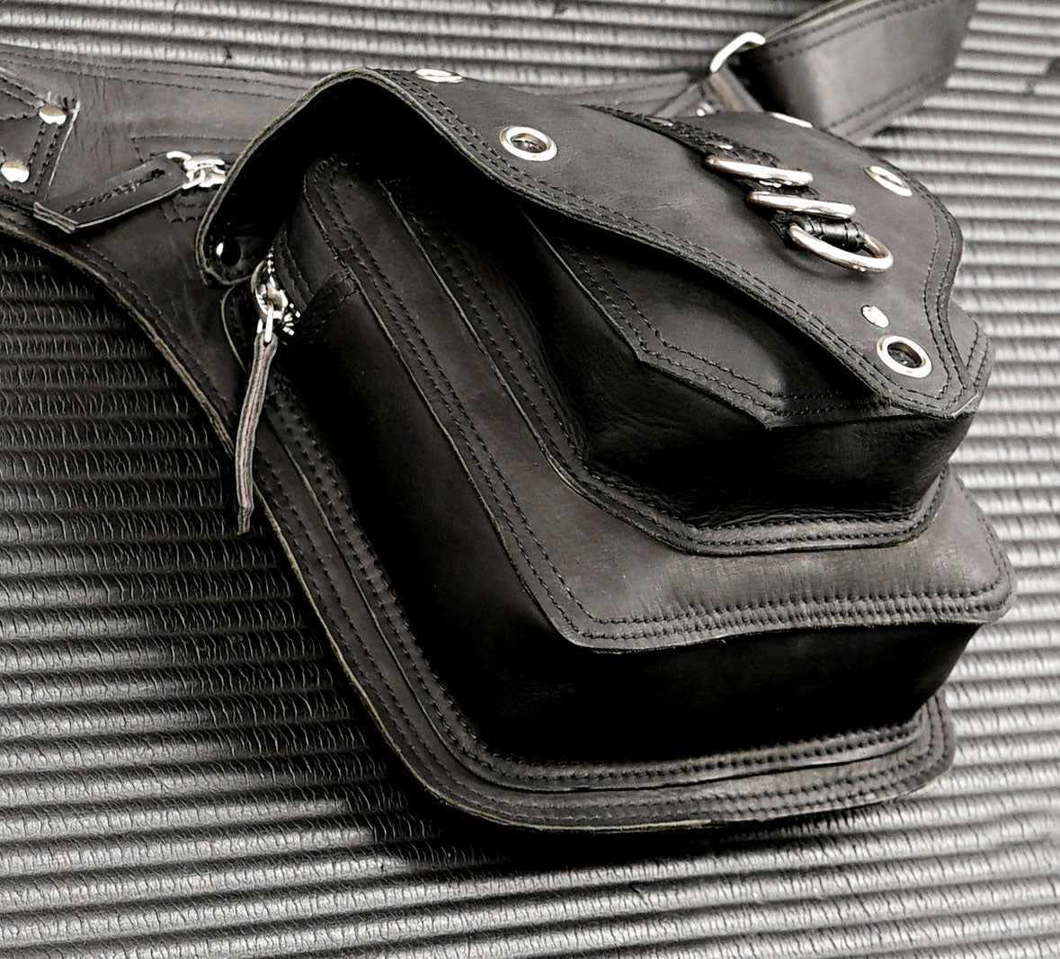 Gothic black leather belt bag with brass studs and eyelets