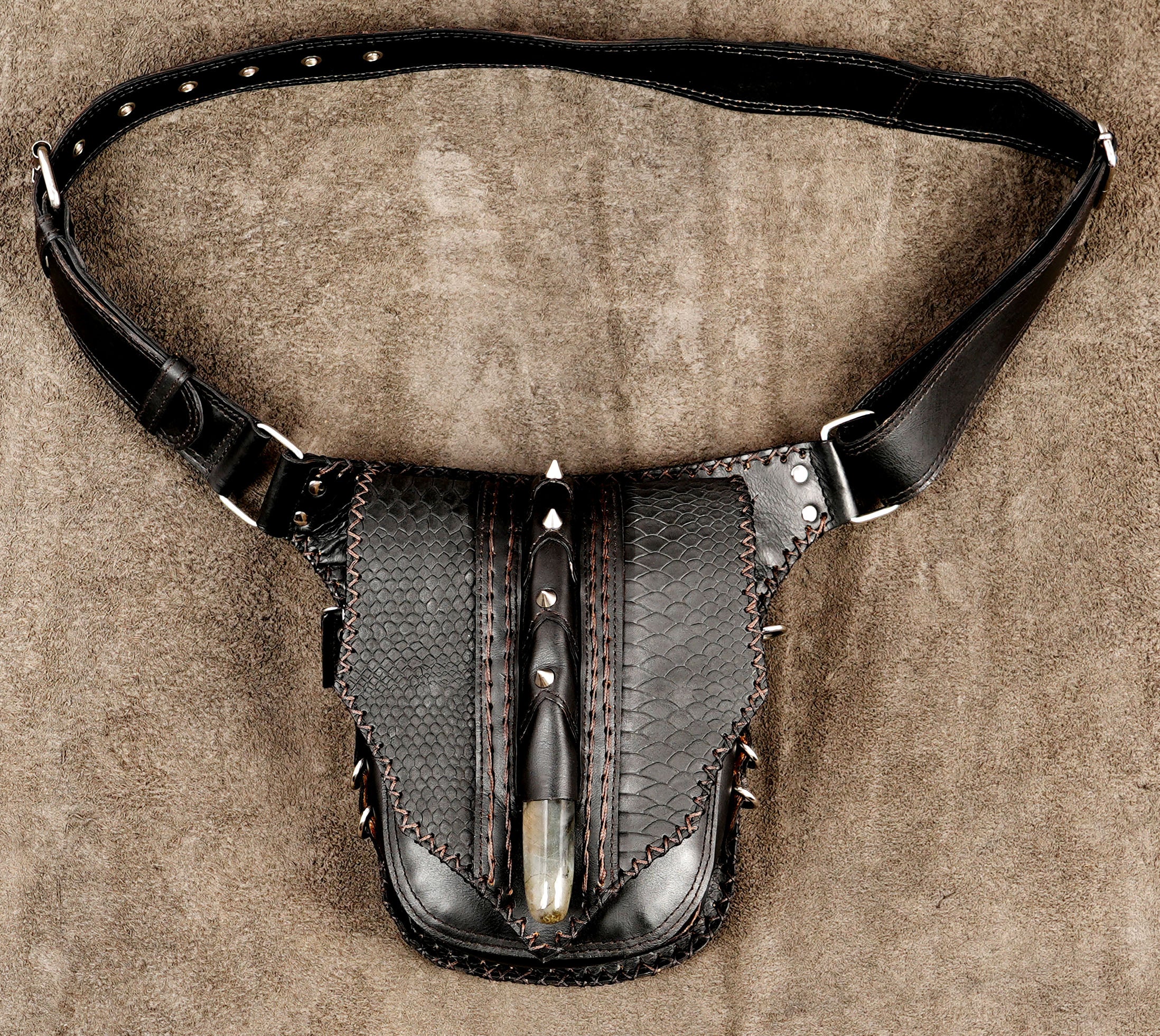 Green leather hip bag with black textured panels