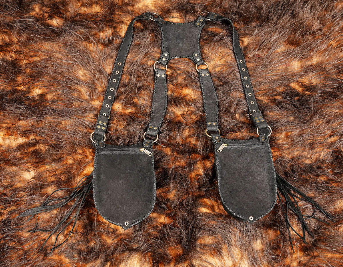 Handmade black leather leg bags with adjustable harness straps for rave wear and festival styling.