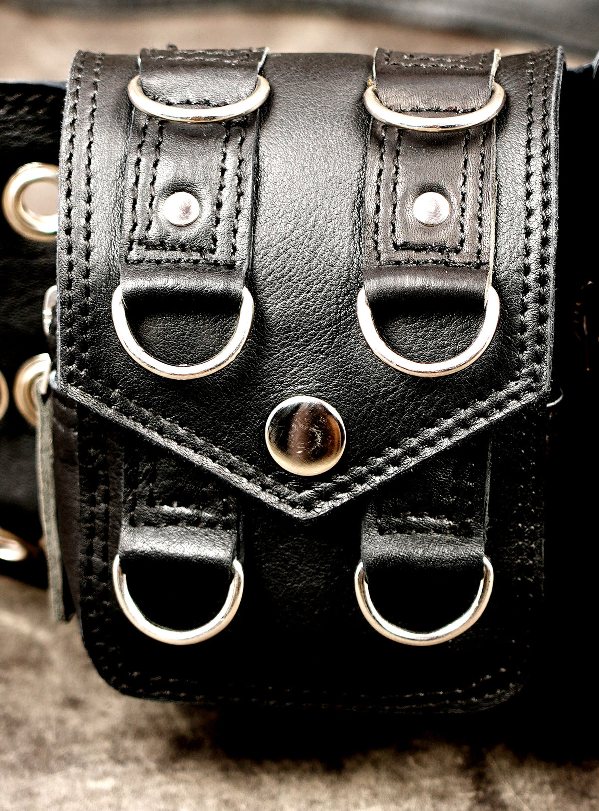Handcrafted leather belt with geometric grommet detail