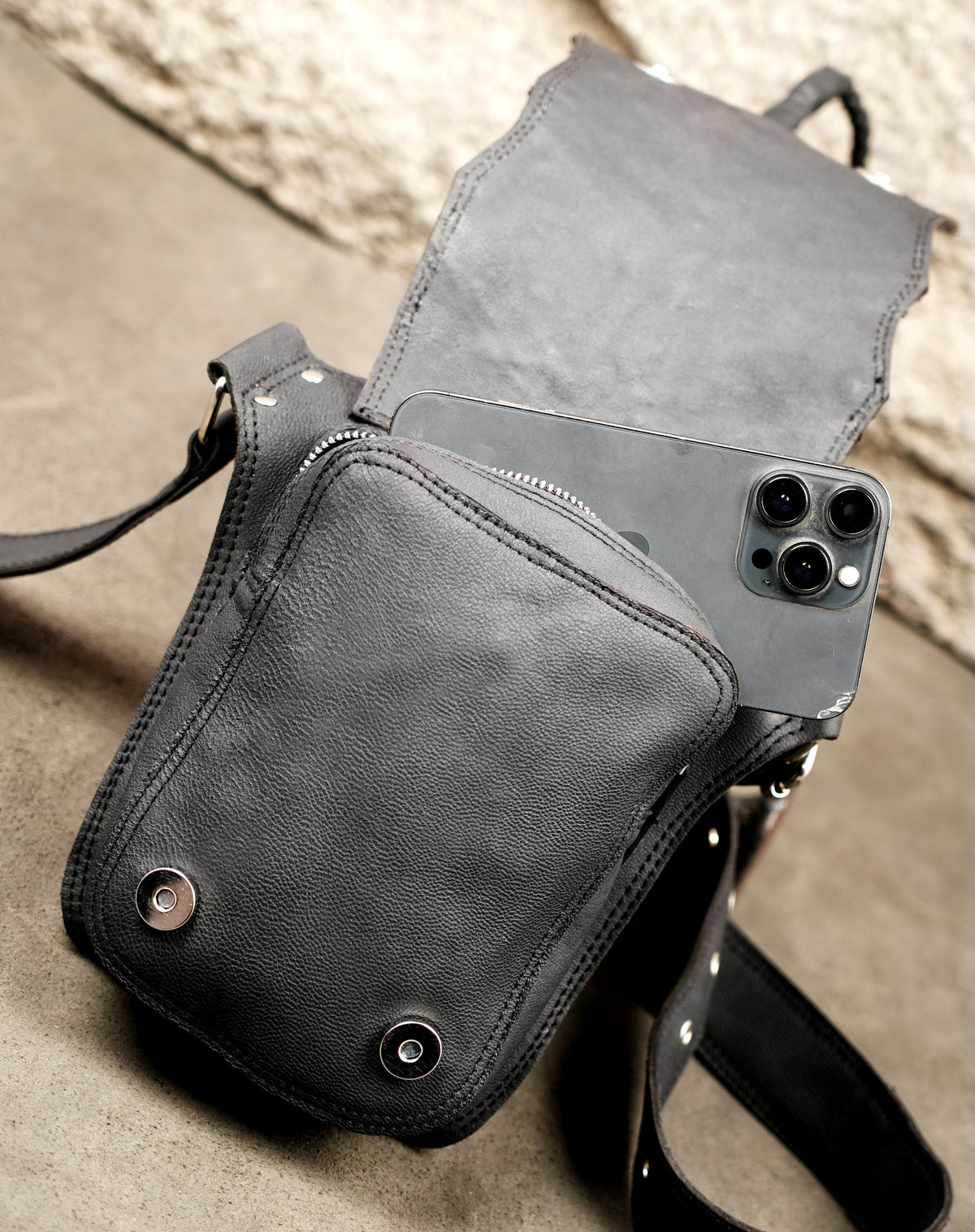 Handcrafted leather waist bag with nickel studs and tassel