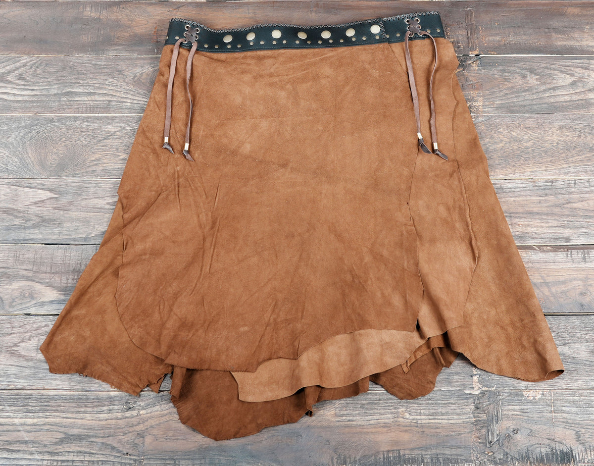 Handcrafted suede skirt styled on rustic wood background