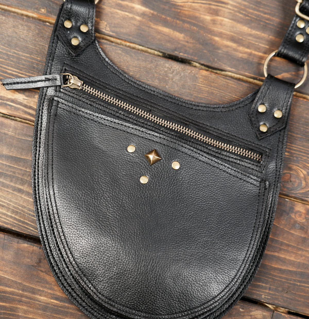 Handmade leather dual pouch bag with black straps, metal studs and secure zipper pockets.