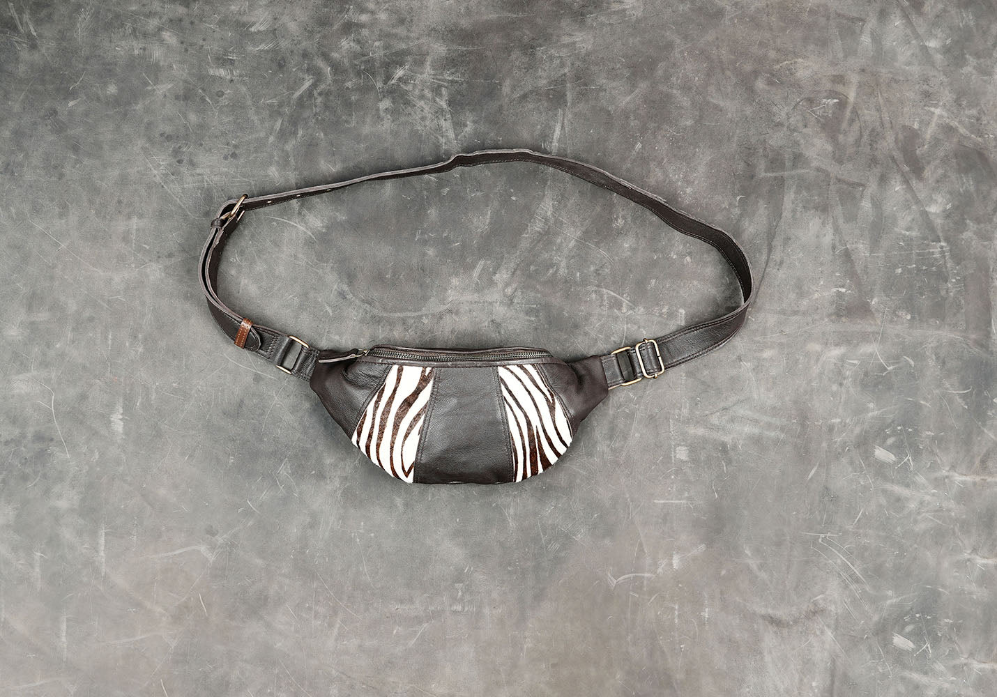 Handmade black leather shoulder bag with zebra-print panels