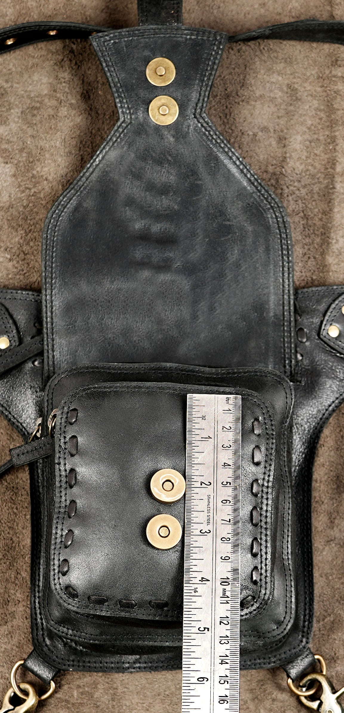 Handmade black leather utility bag with leg support