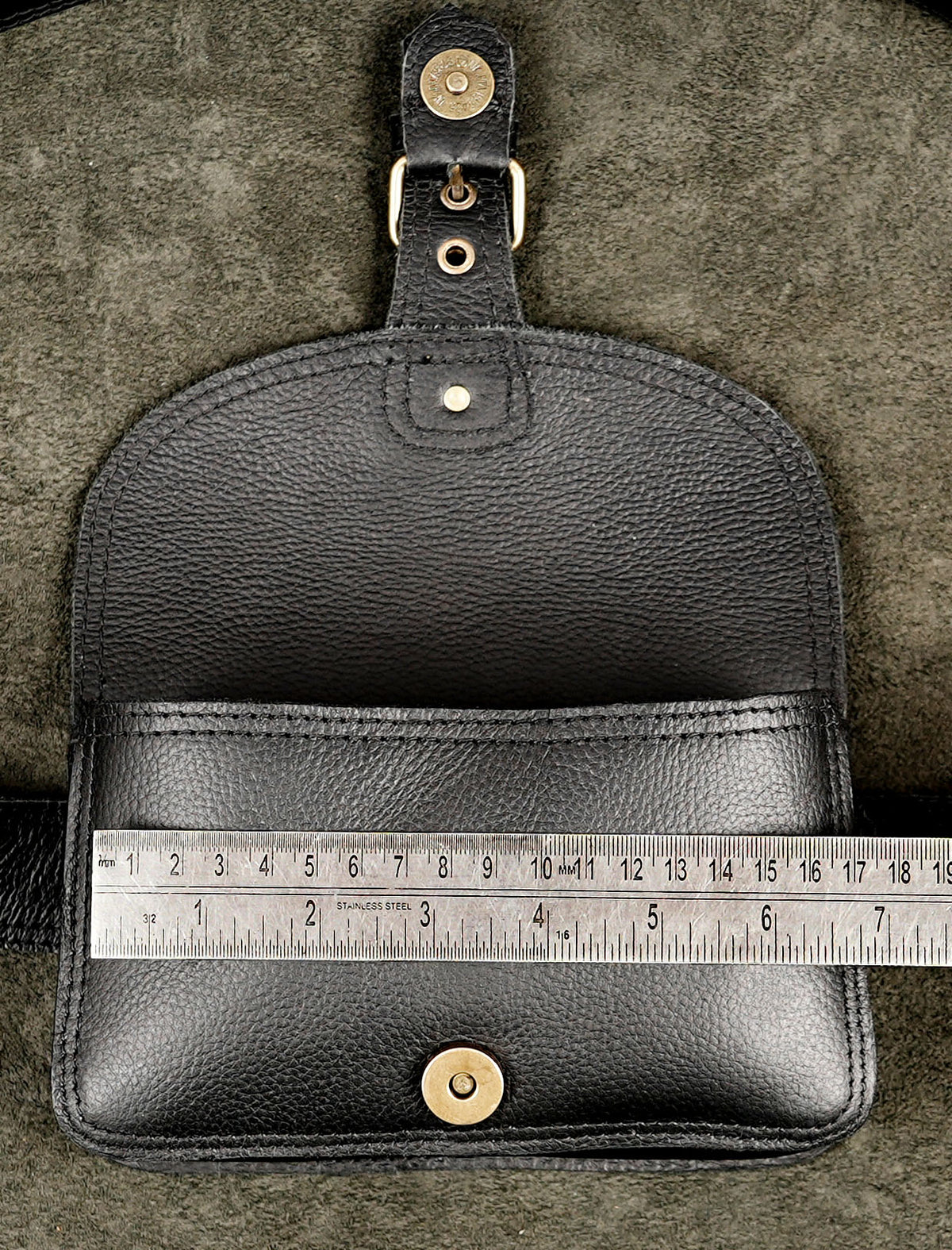 Classic black leather bum bag with adjustable buckled strap for hands-free travel