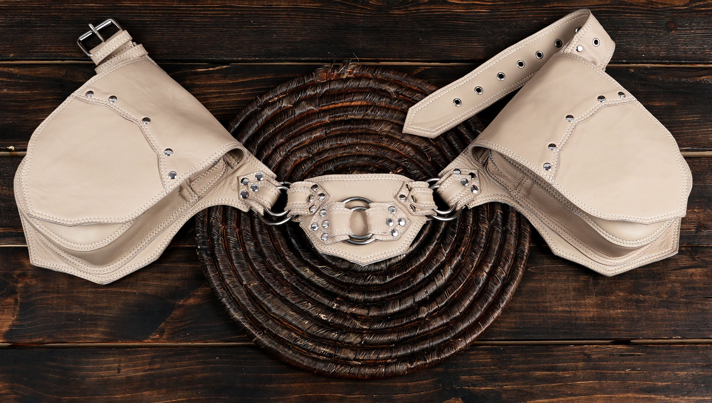 Ivory leather belt with dual rounded pouches, flat lay